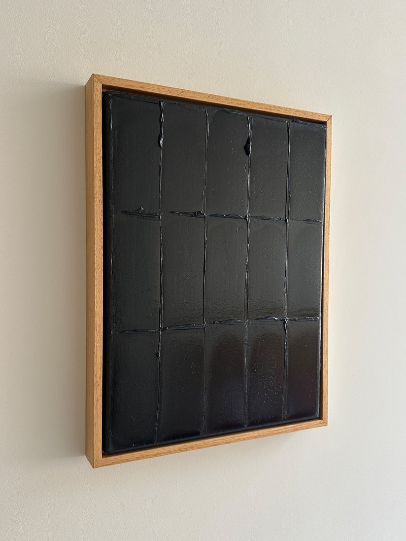 Abstract black paint grid artwork in natural wood frame by Roi Elmaliah