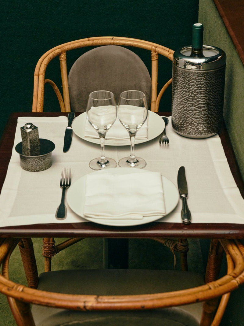 Wine Cooler in Burnished White Bronze — placed on dining table with glassware