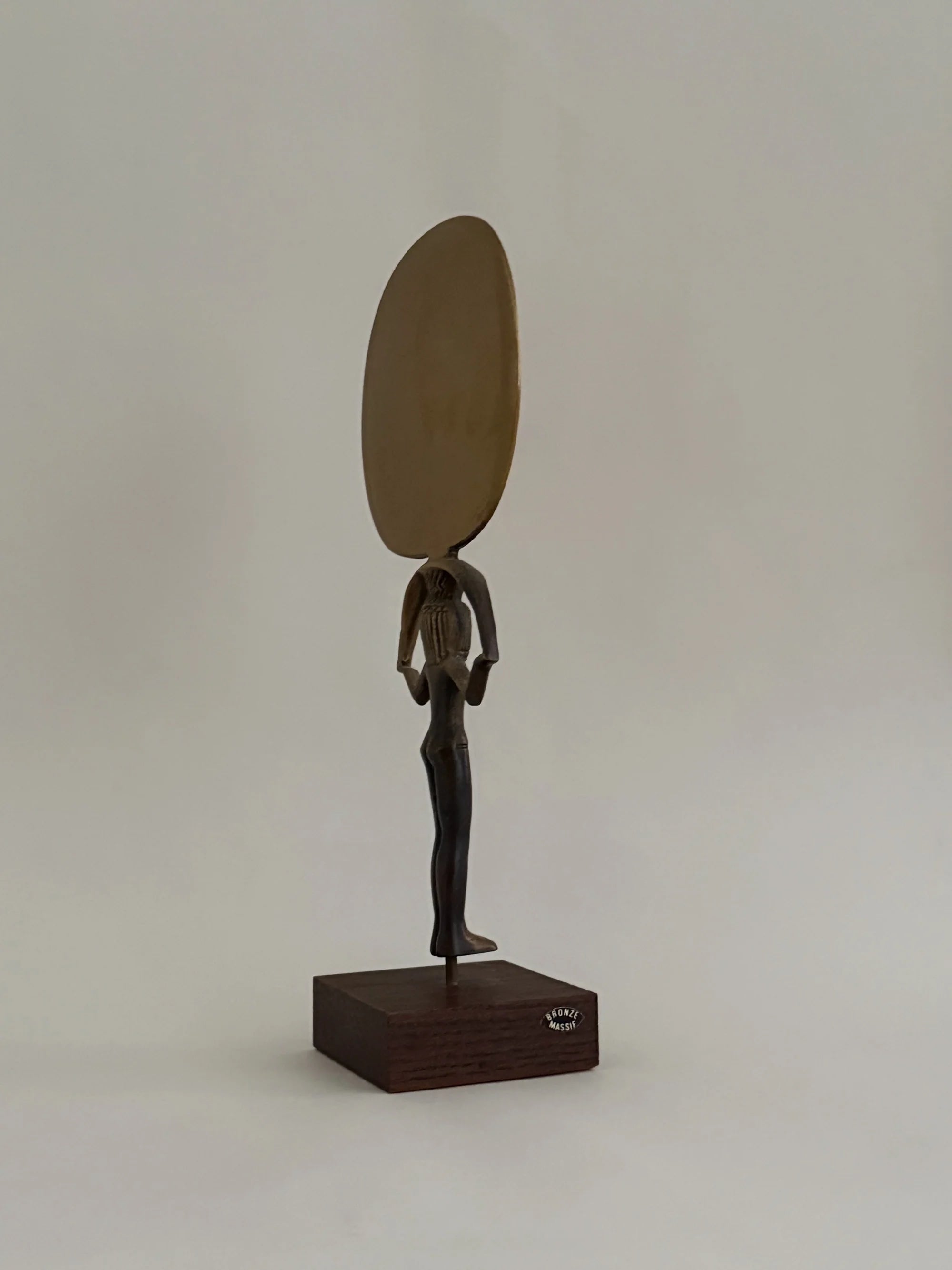 Bronze Sculpture of Isis Holding a Mirror — angled view on wooden base