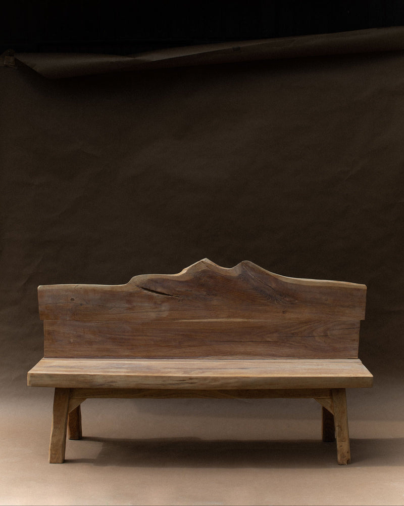 Brutalist walnut wood bench with sculptural backrest on platform base