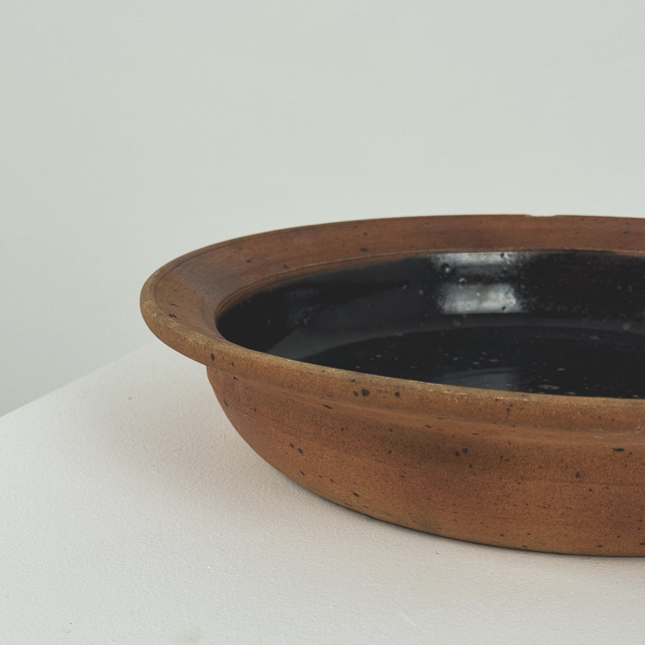 Profile view of Pierre Digan stoneware bowl showing curved rim detail