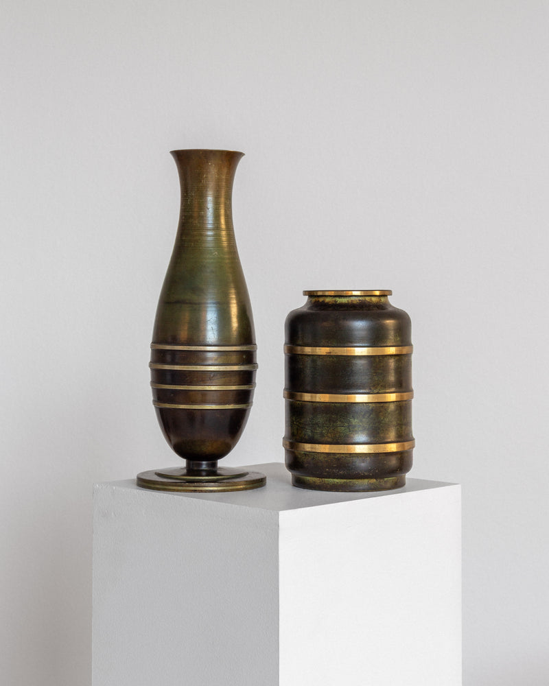 Modernist bronze and brass vases with banded detailing on pedestal