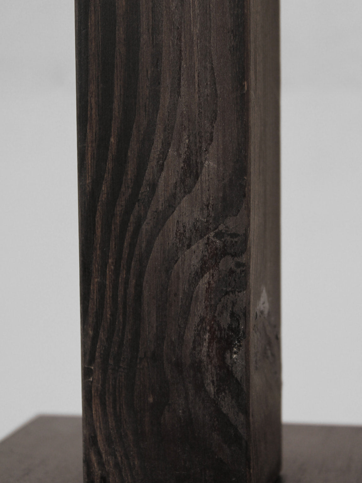 A close-up of the Vintage Stories Mid-Century Swedish Wood And Iron Tall Lamp shows its rich wood grain and natural textures, featuring a textured paper lampshade and standing out against a simple, light background.