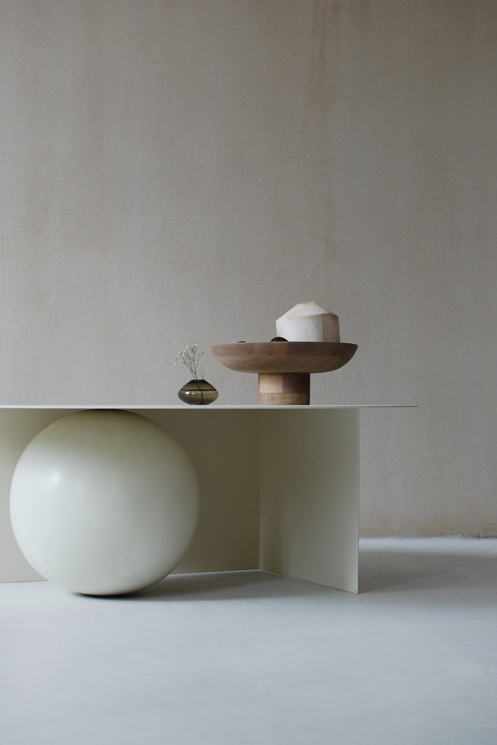 FUKU Coffee Table — angled view with cream finish and decorative bowl