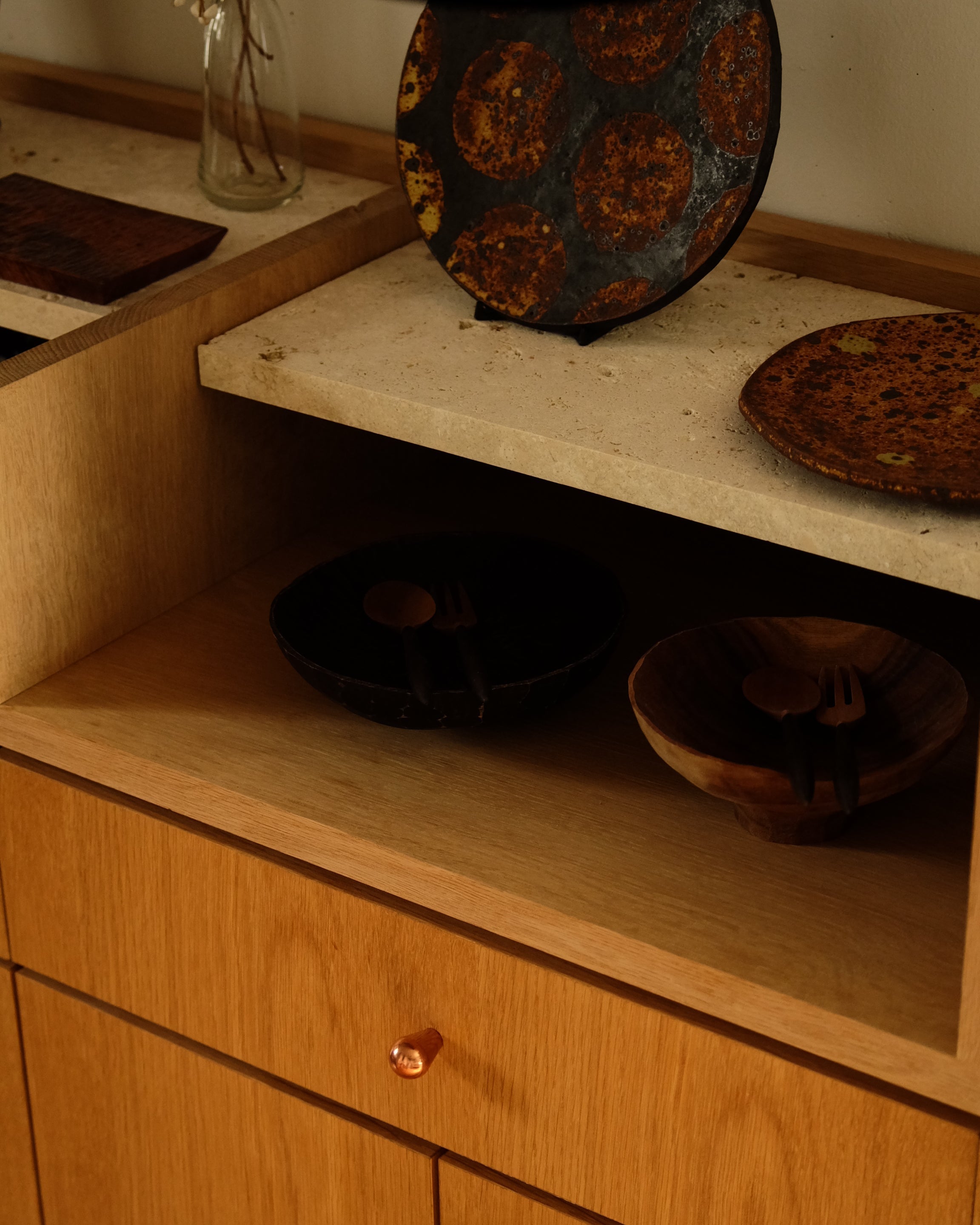 LUA Cabinet Knob — top view on wooden cabinet with bowls