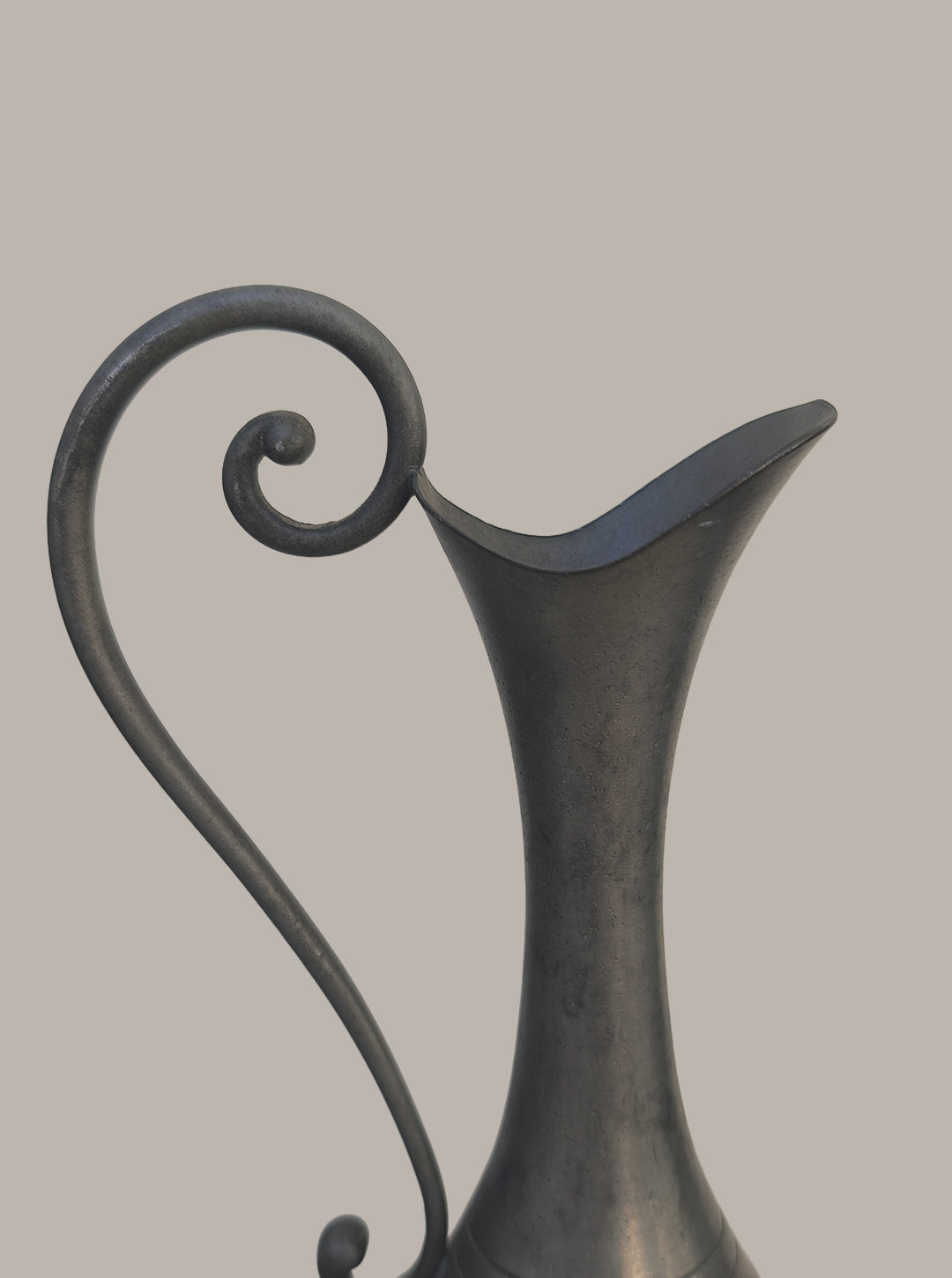 Pewter Vase — close-up of curved handle and spout