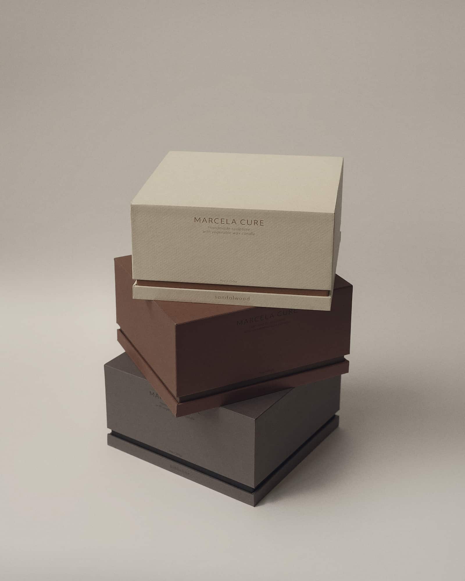 Contemporary Sculptural Candle in Resin and Stone – Tobacco by Marcela Cure — side angle of stacked candle boxes