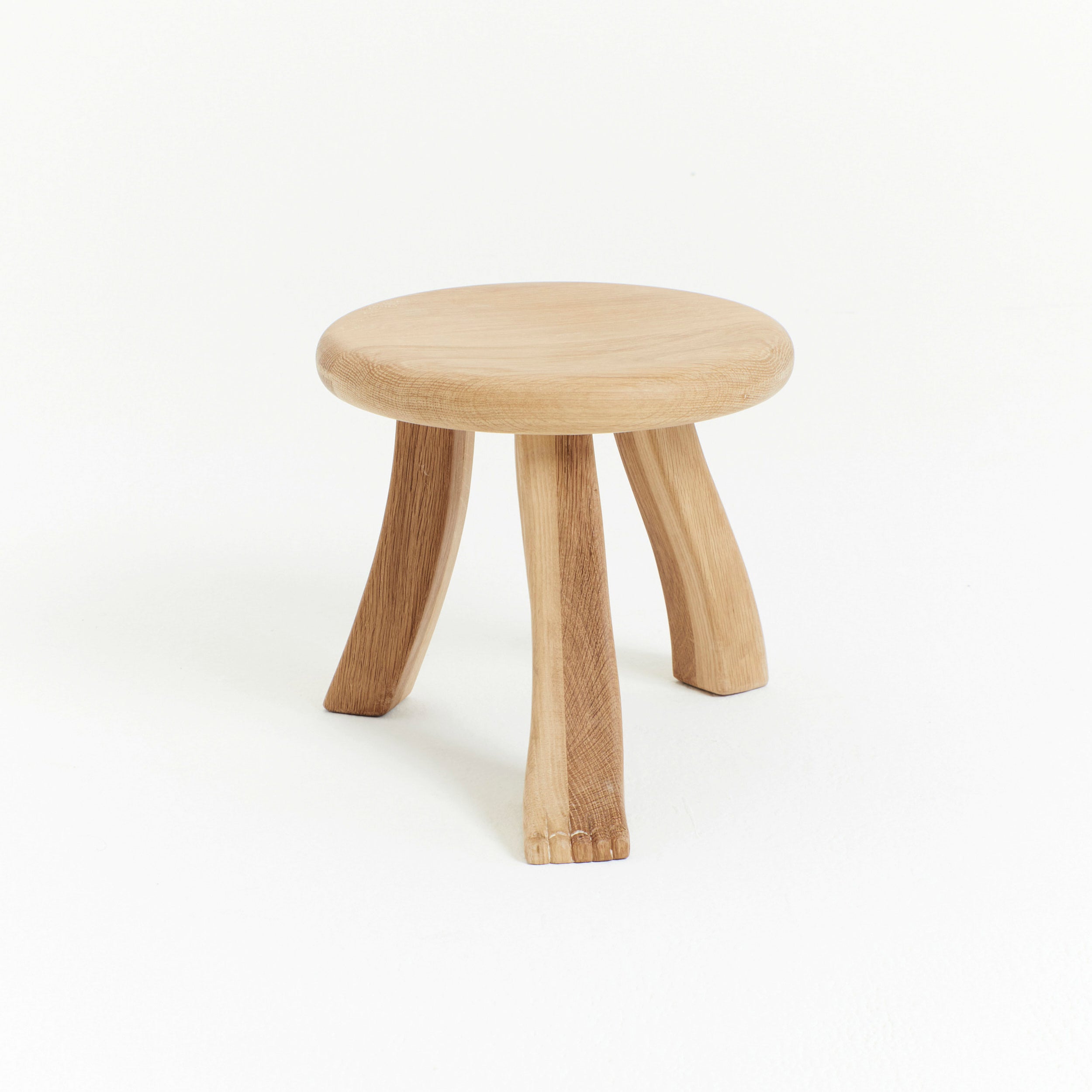 Foot Stool in Oak — side angle showing natural wood grain and legs