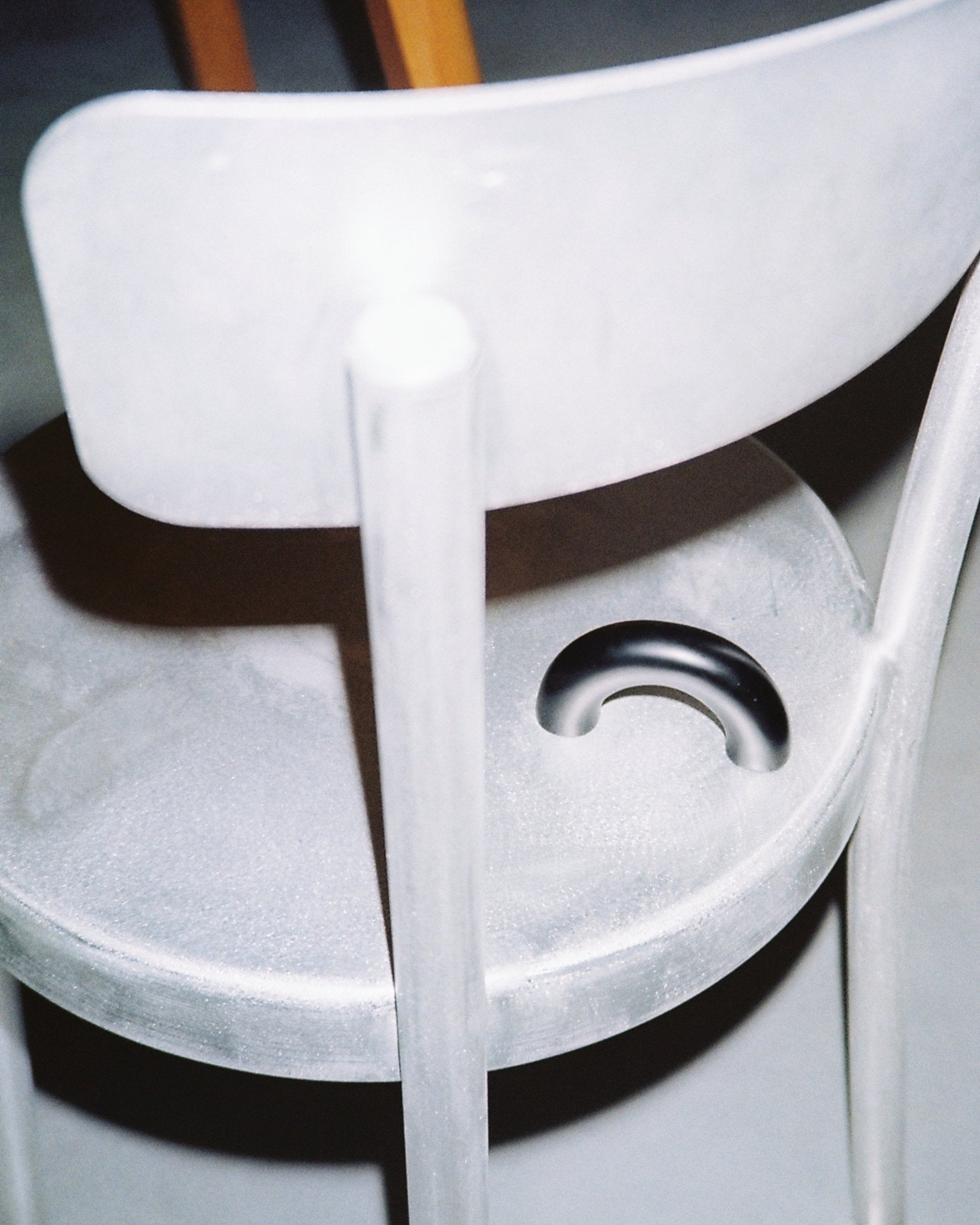 CERCLE Cabinet Pull Thick — black pull resting on gray chair