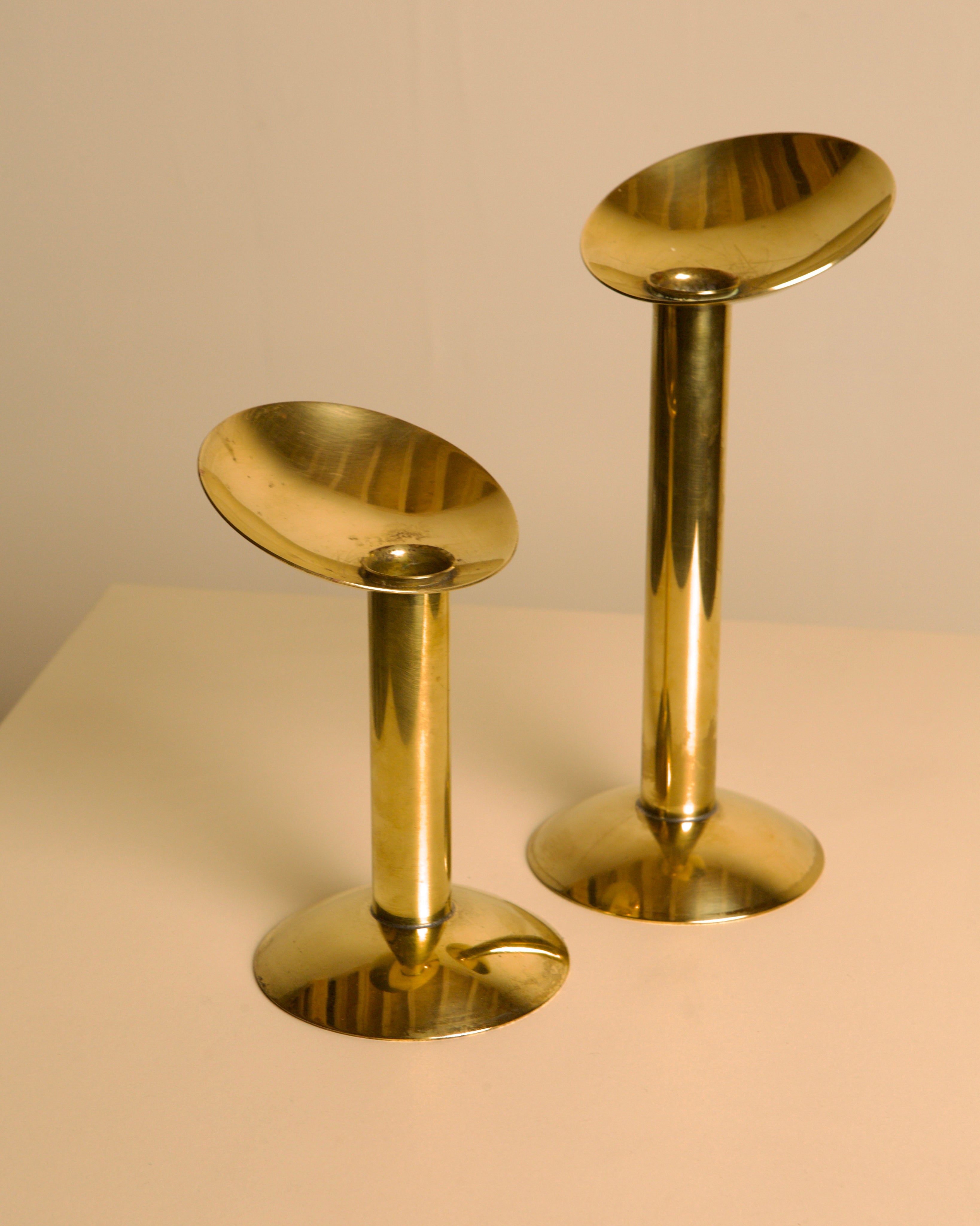 Pair of Danish Brass Candleholders 1960s — side angle on neutral background