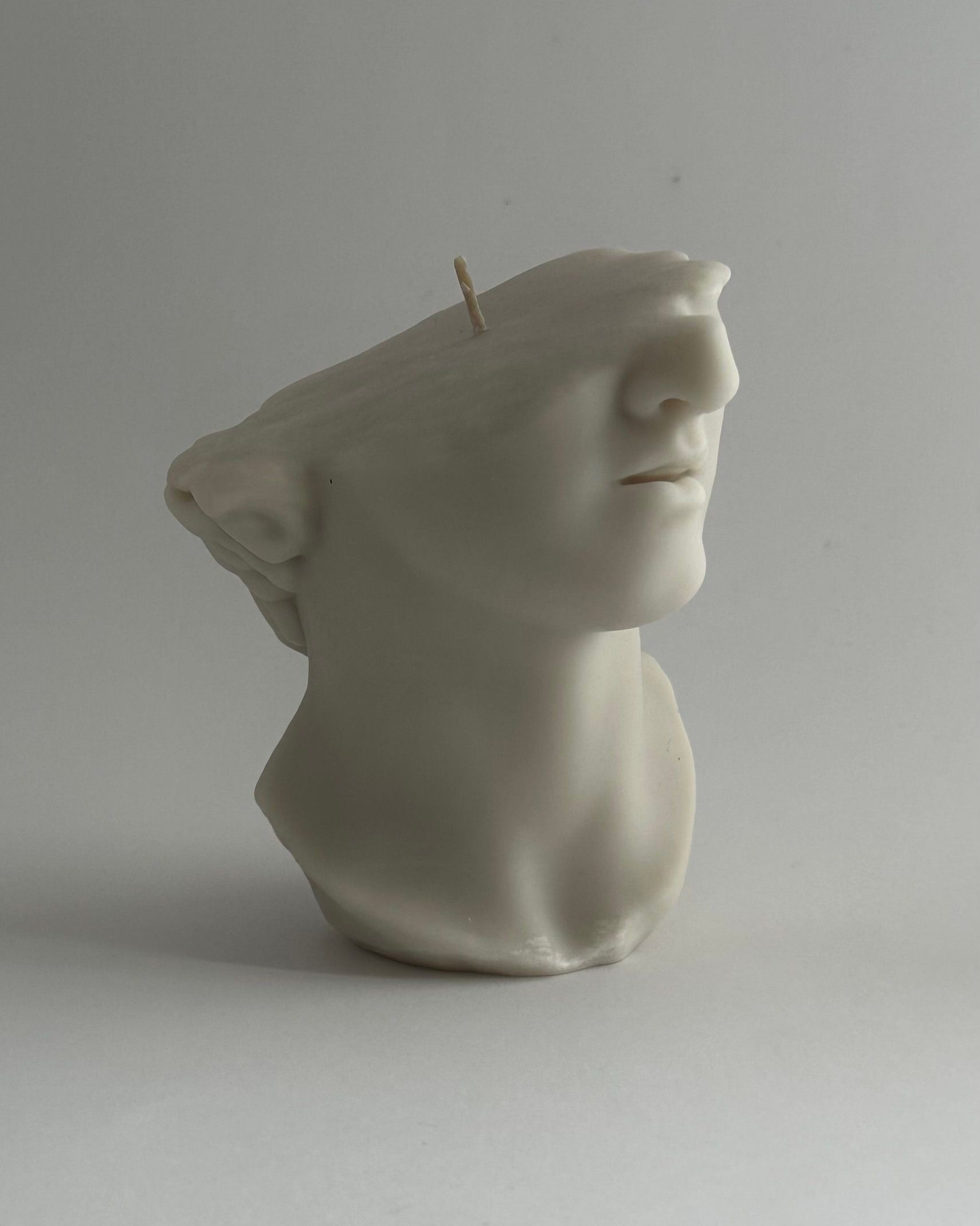 THE GREAT' candle — close-up of white ceramic face sculpture