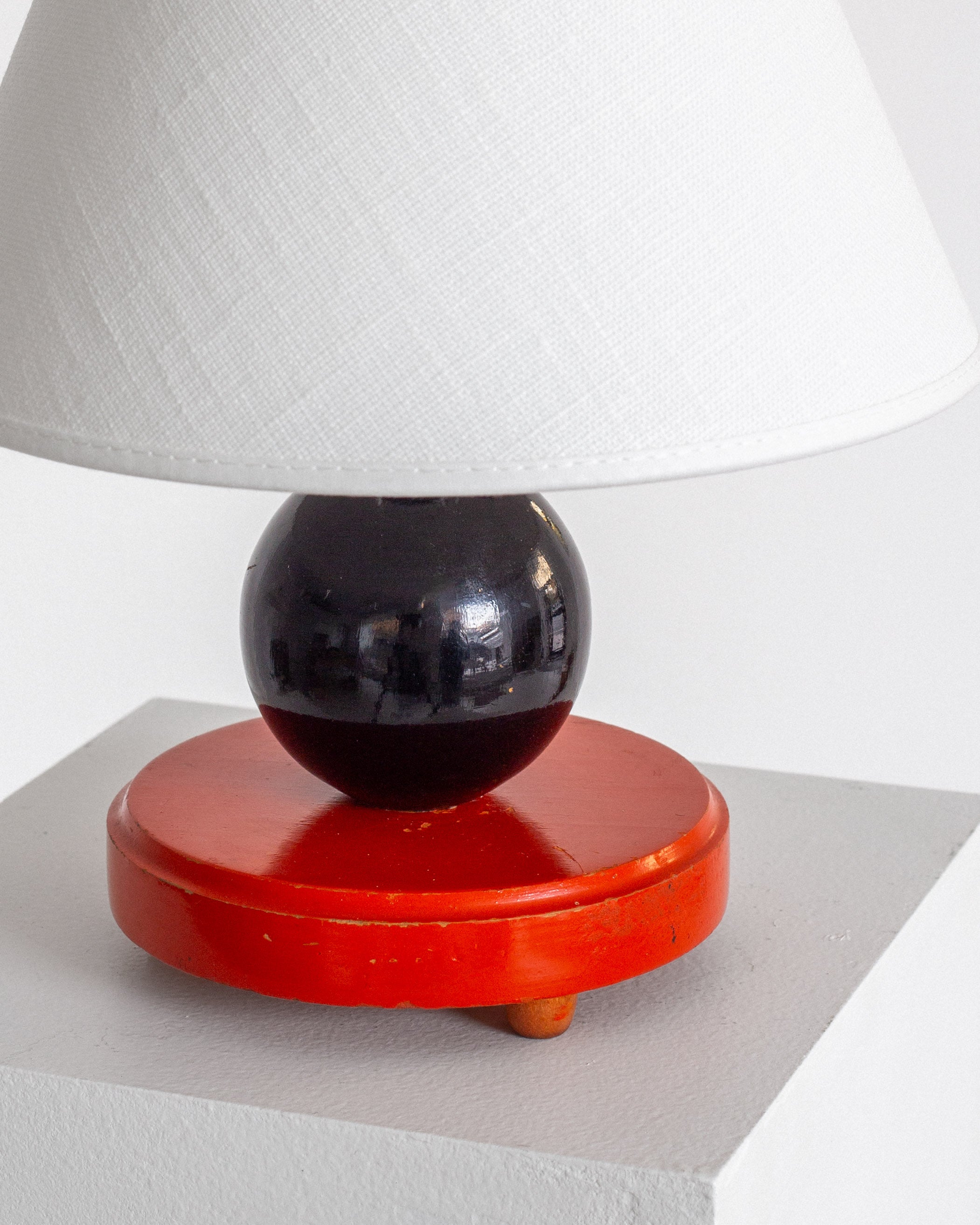 Petite Wooden Art Deco Table Lamp — side angle showing red base and black sphere