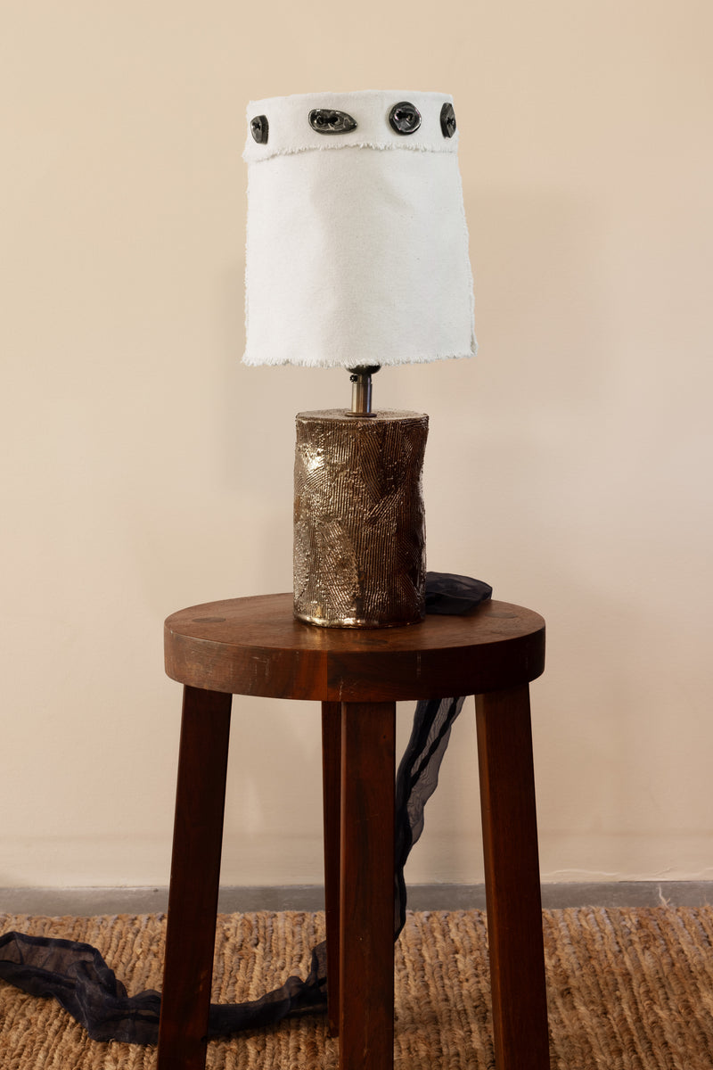 Tender Buttons — close-up of ceramic lamp base with fabric shade