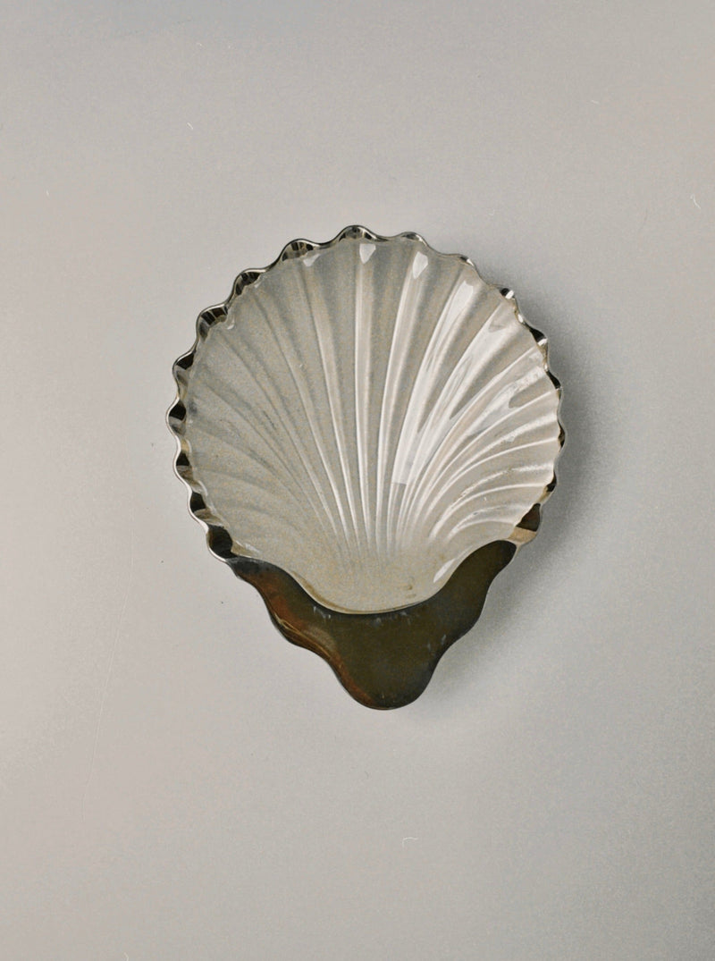 Silver shell-shaped decorative dish with scalloped edges