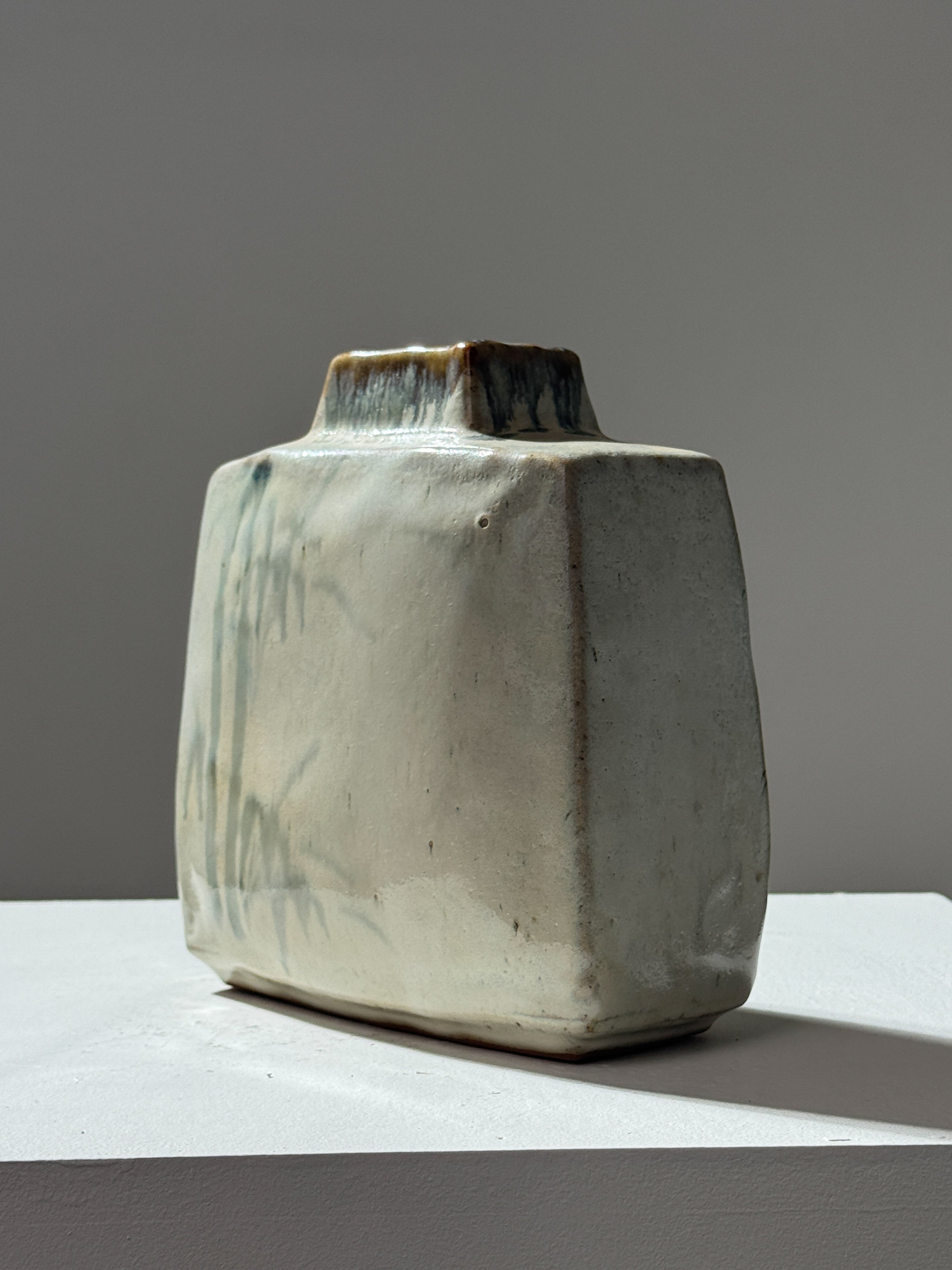 Angular ceramic vase with organic drip glaze in sage green tones