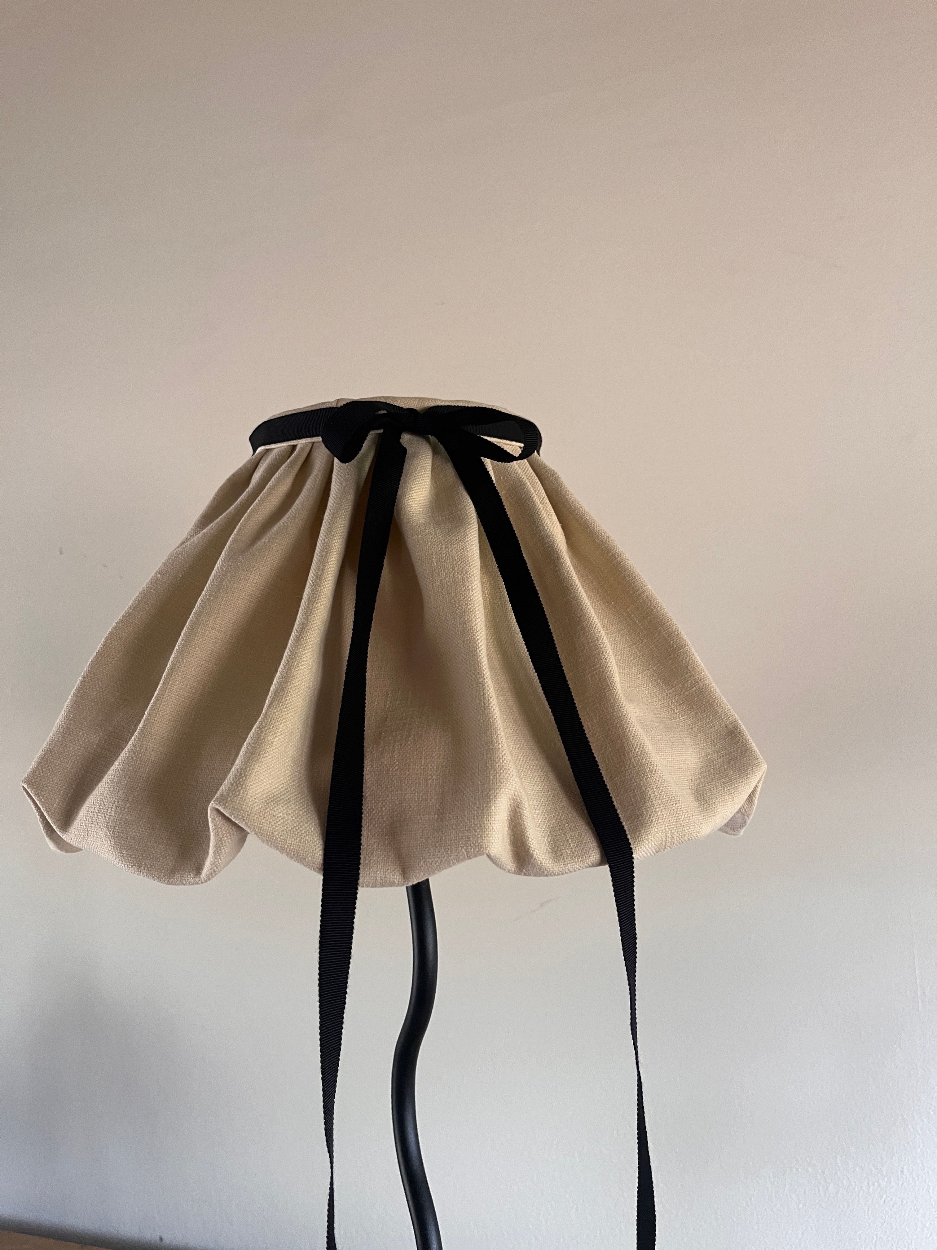 The "Puffball" Lampshade — close-up of cream fabric with black ribbon