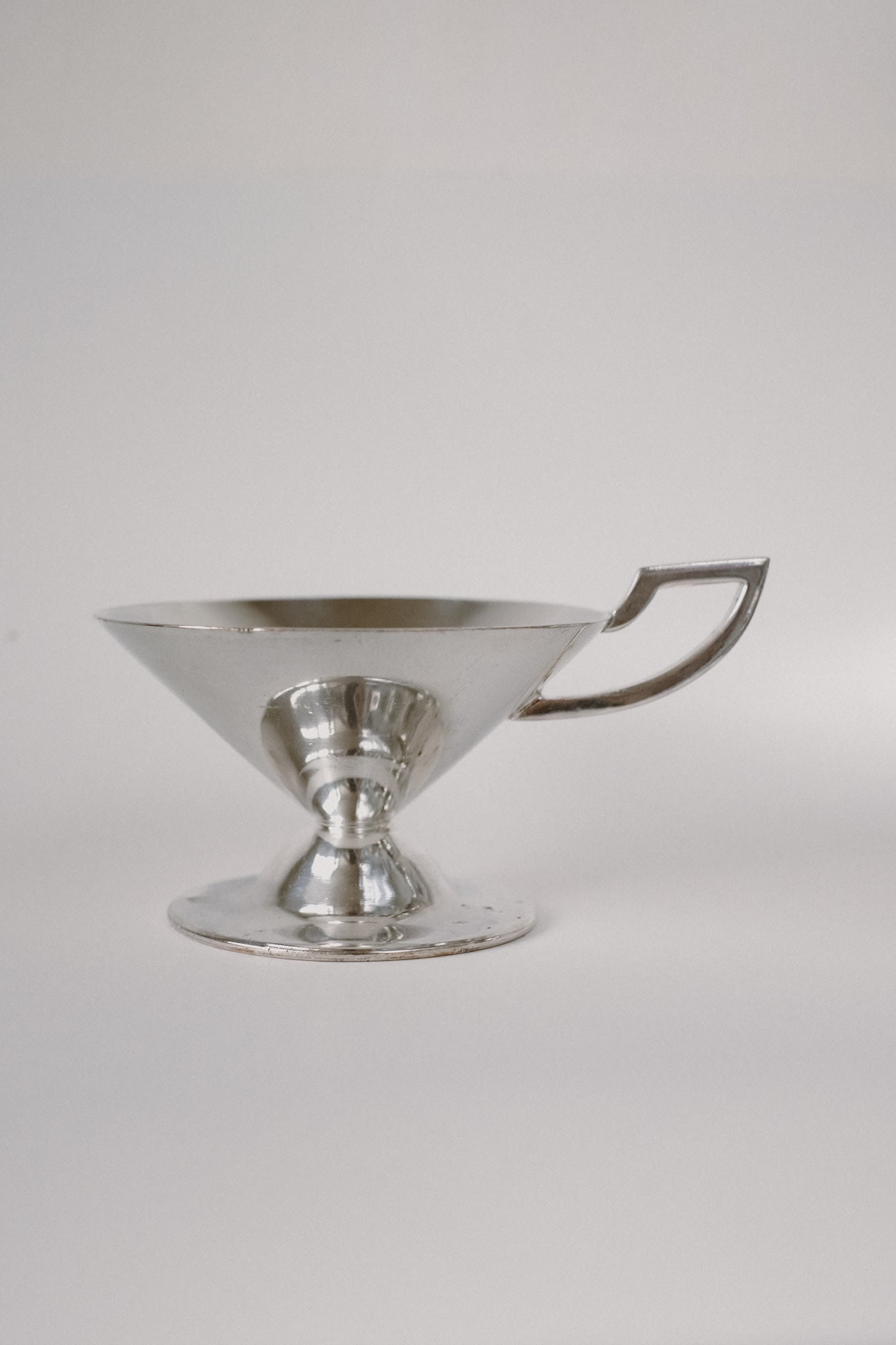 Set of Serving Cups in Silver — side view on neutral background