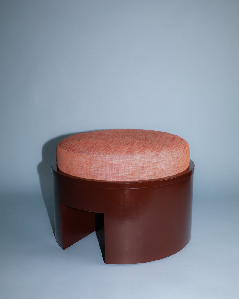 Roan round ottoman with coral upholstery and walnut base detail