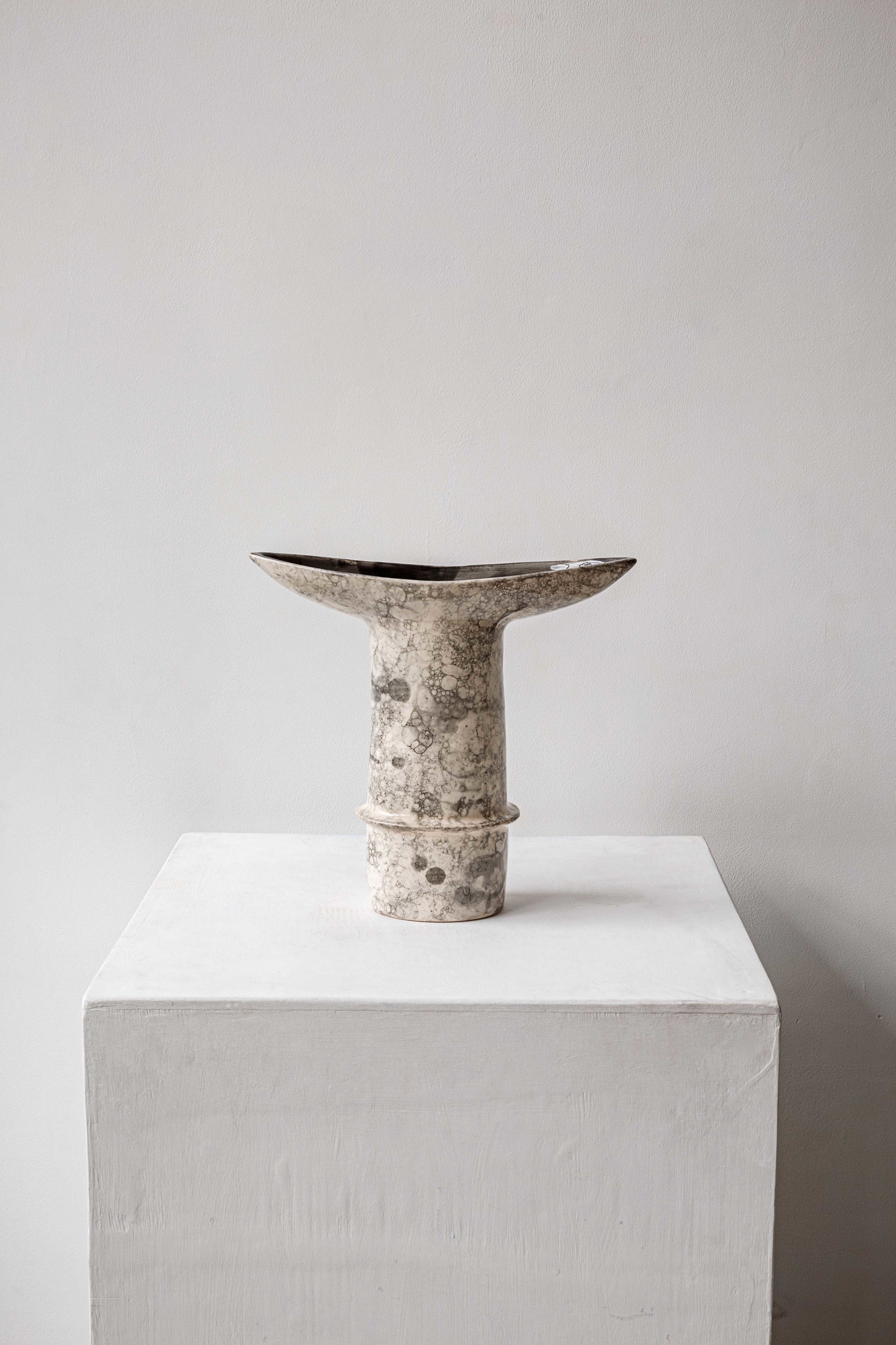Dyka Ceramic Vase — top view on white pedestal