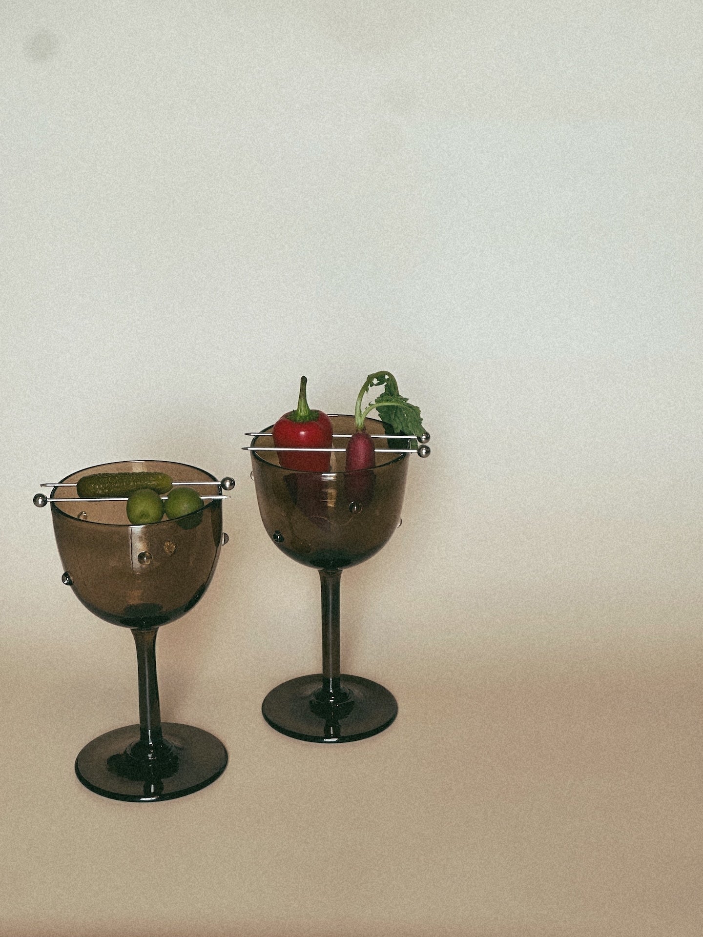 NOA GOBLET cocktail Glass — two glasses with vegetables on neutral background