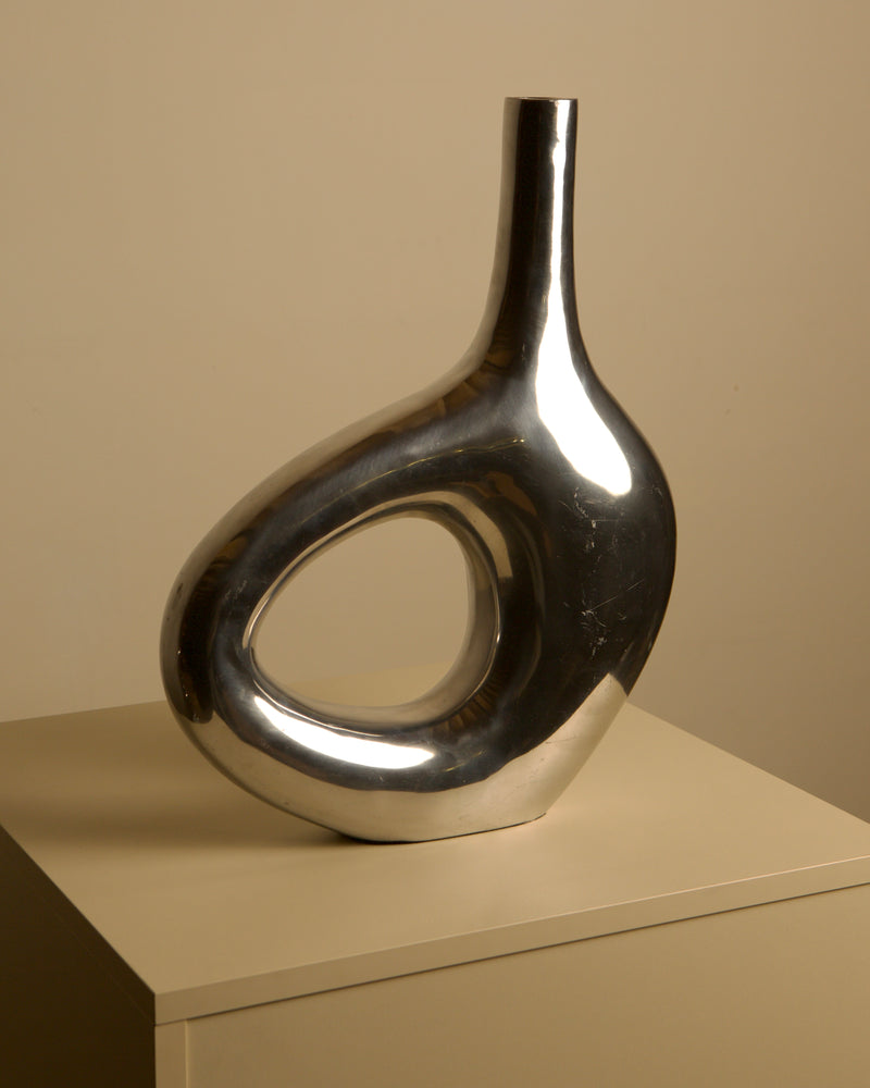Large Italian cast aluminum vase from the 80s — close-up of shiny metallic surface