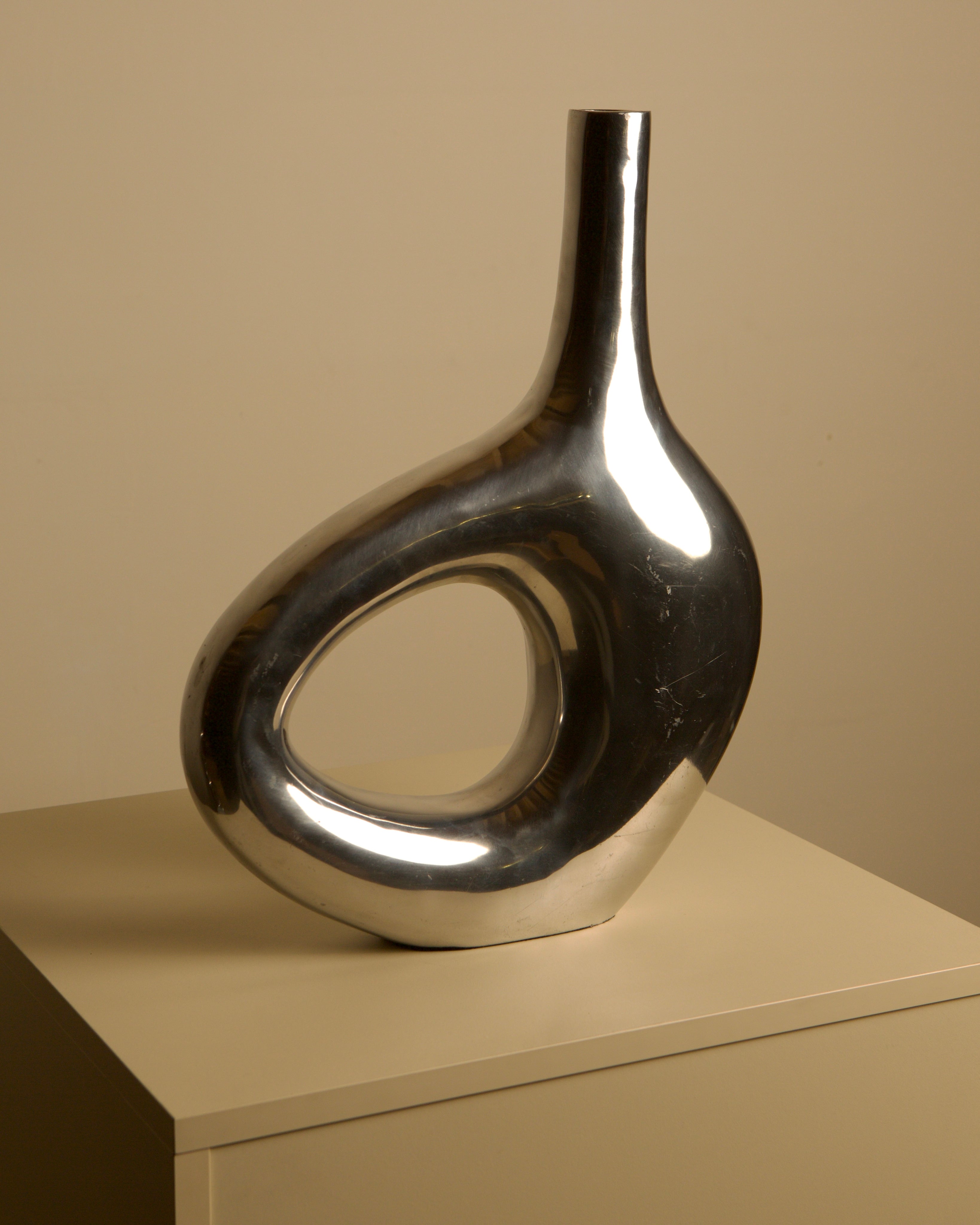 Large Italian cast aluminum vase from the 80s — close-up of shiny metallic surface