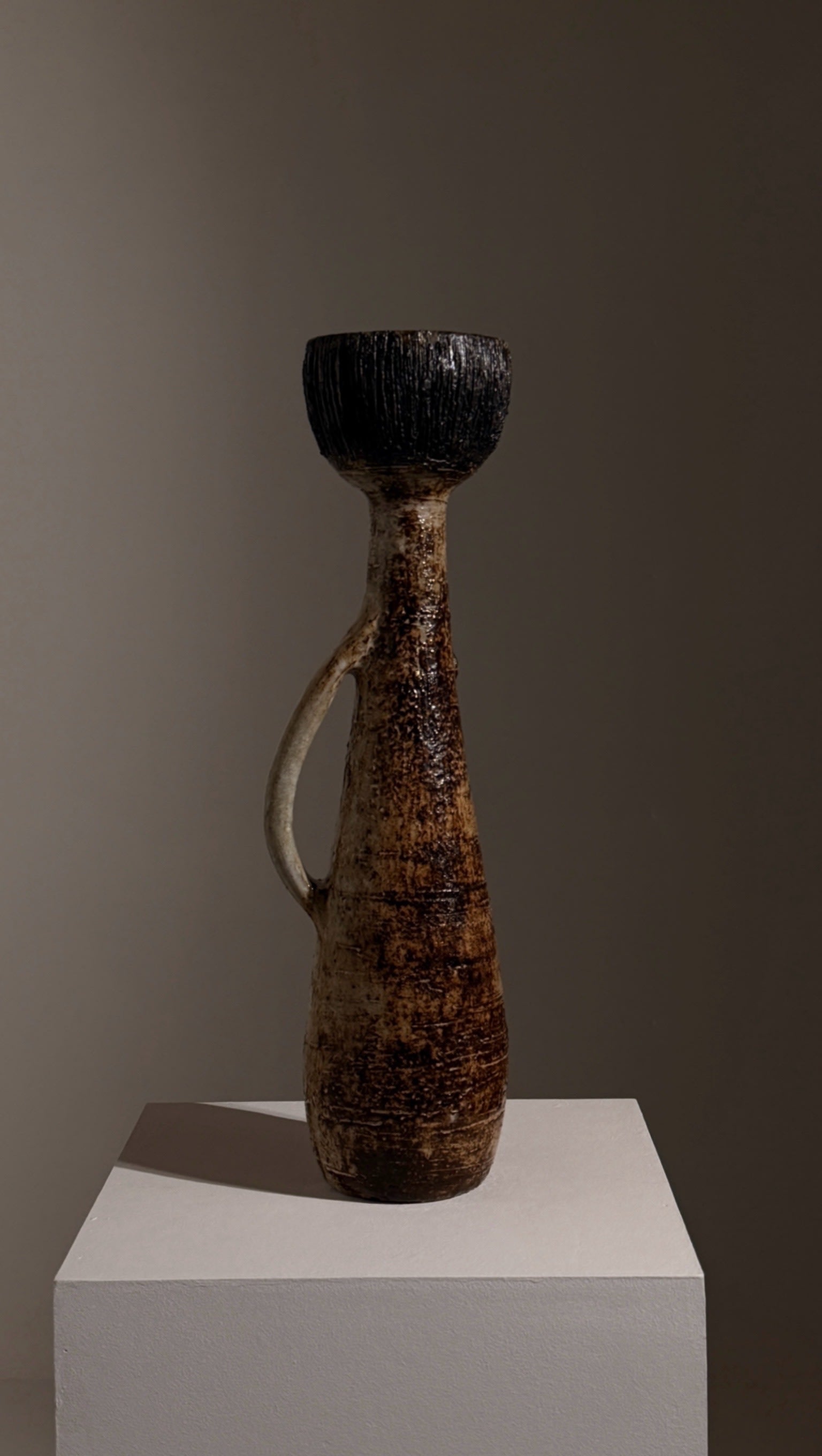 Monumental anthropomorphic pitcher by Jacques Pouchain — side view on neutral backdrop