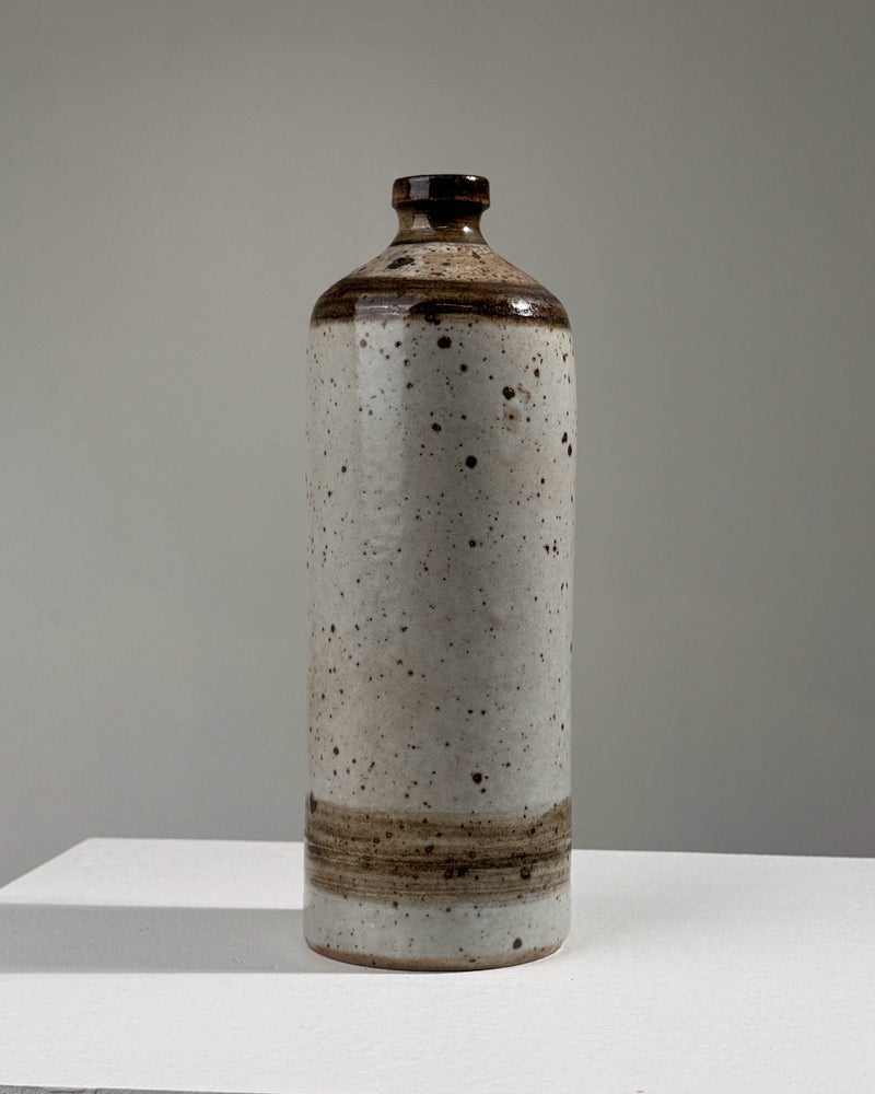 Pyrited stoneware bottle vase with speckled white glaze finish