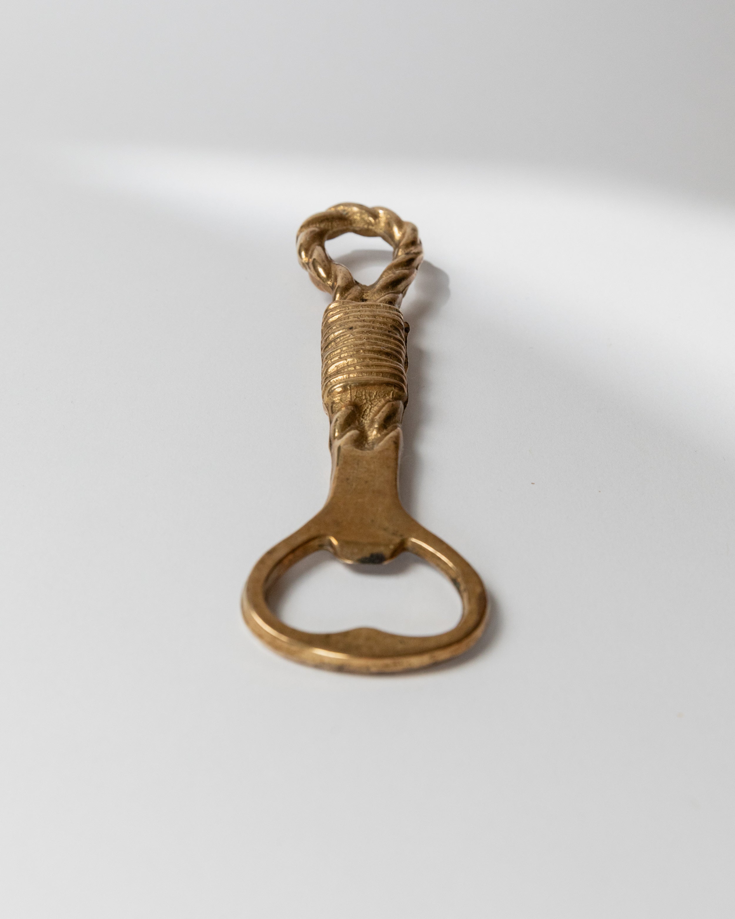Vintage brass bottle opener with twisted rope handle detail Italy 1960s