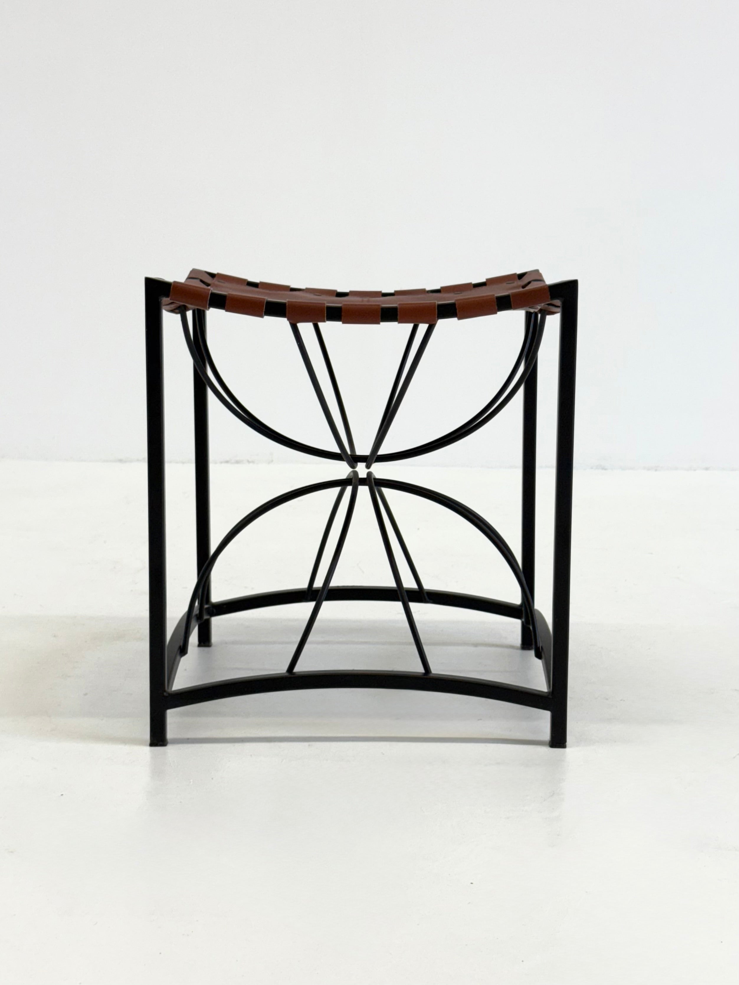 Elegant vintage French stool with black metal and brown leather — detail view