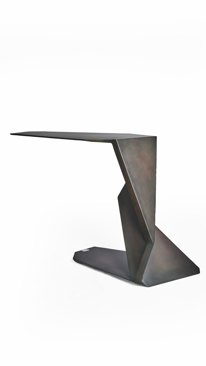 SAMOTRAX Table in Metal — angled view highlighting geometric design and finish