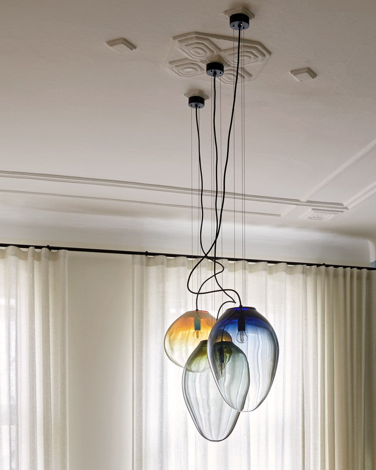 CERES pendant - size M (H:40cm), L (H: 43cm), XL (H:49cm) — side angle showing colorful glass shades hanging from ceiling