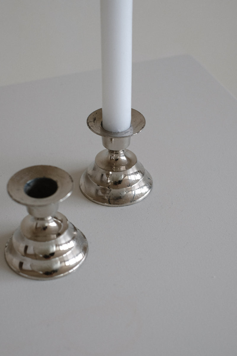 Set of 2 Candle Holders — close-up of polished metal surface