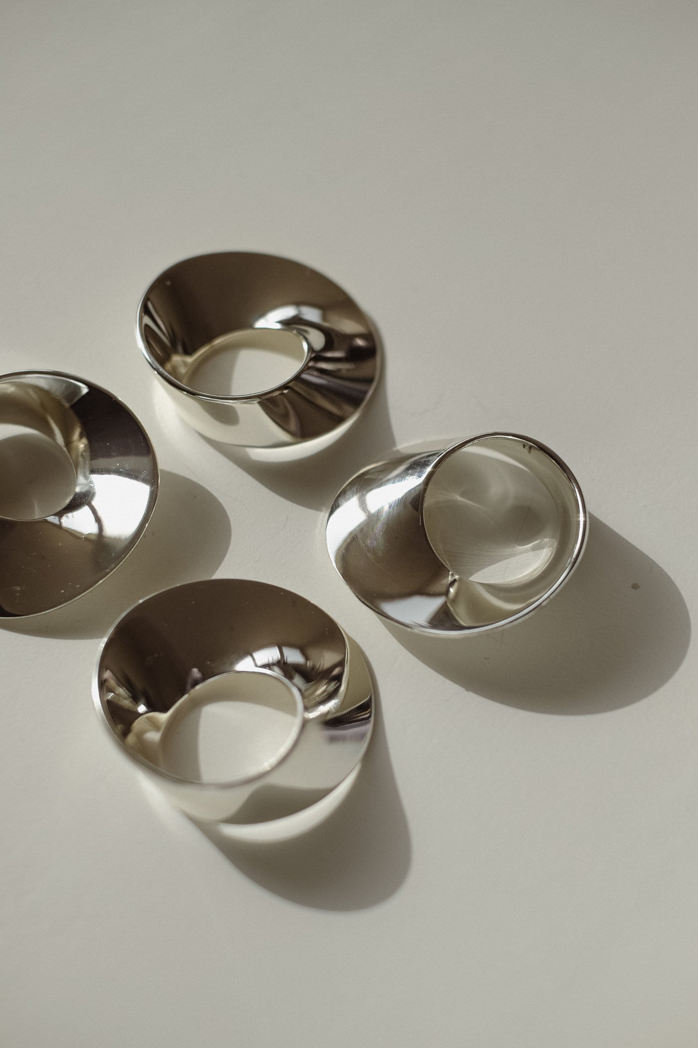 Set of 4 Silver-Plated Napkin Rings — overhead view on light surface