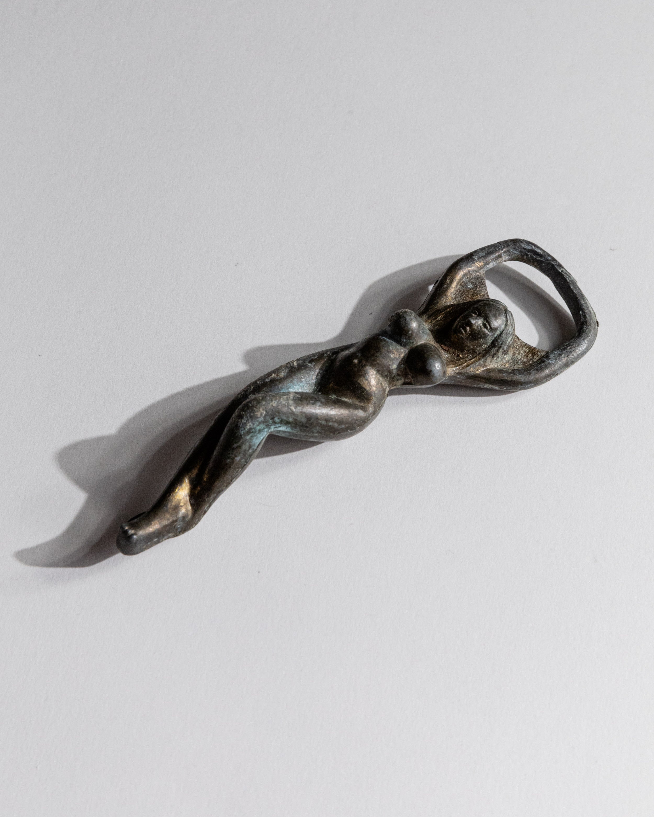 Vintage 1940s Bottle Opener Brass, Nude Woman Shape — angled view on white background