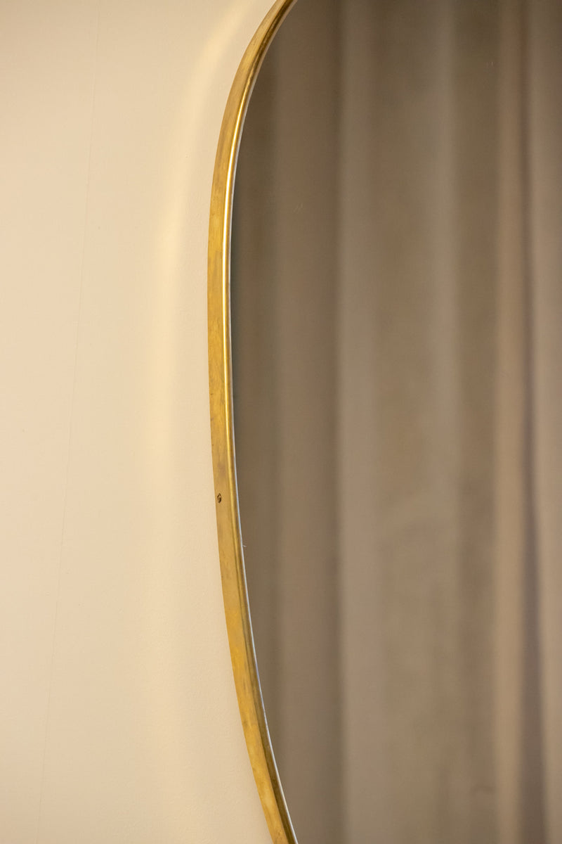Large Mid-Century Italian Brass Shield Mirror — close-up of brass frame edge