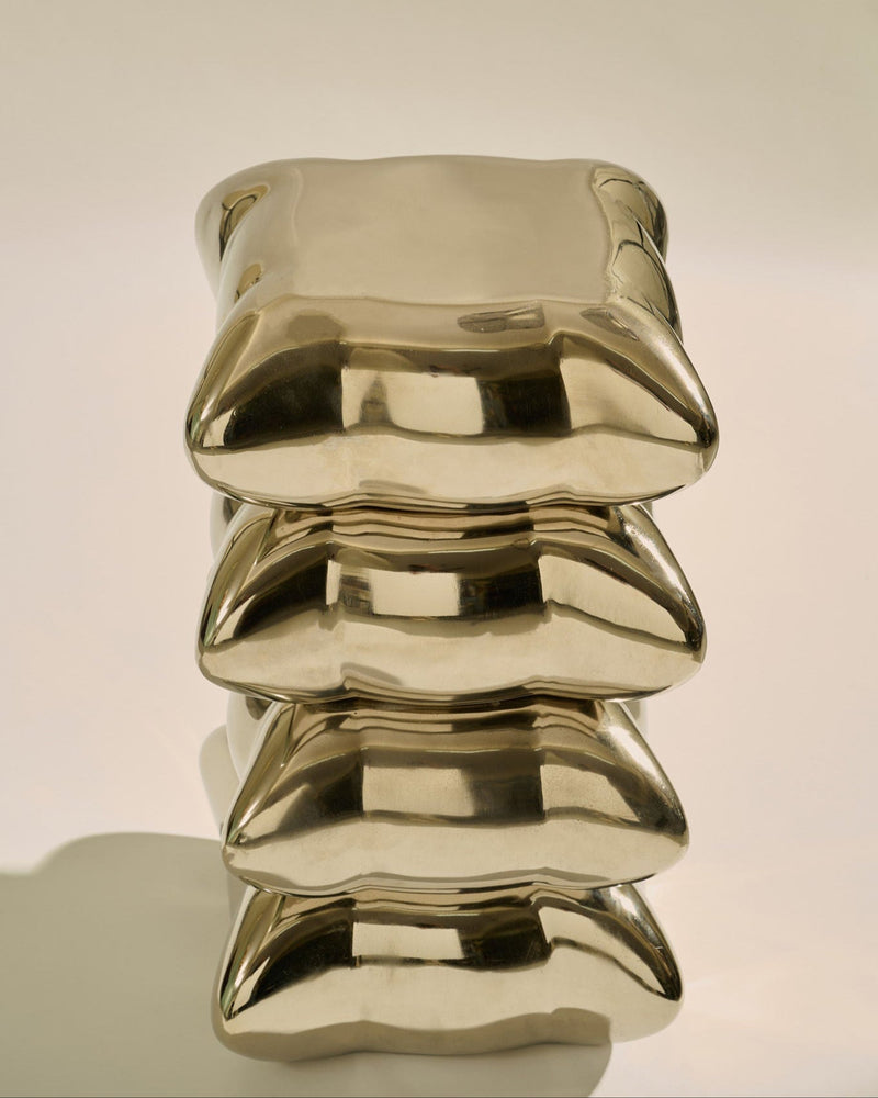 Pillow Drink Table — close-up of shiny gold surface texture