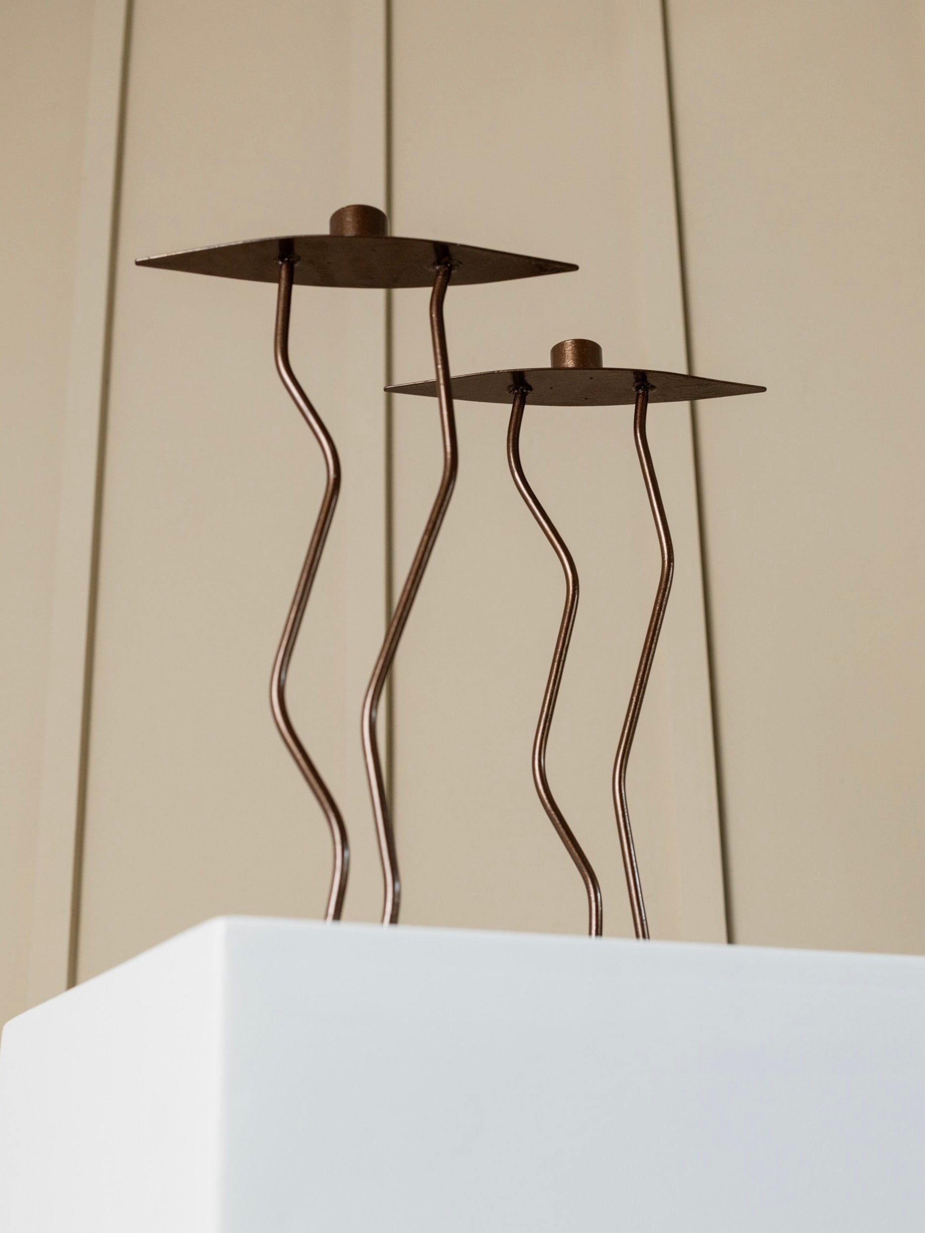 Two Metal Candlesticks Memphis Style — angled view on white pedestal