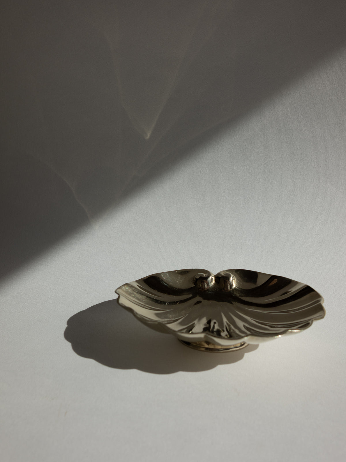 French Art Deco Polished Brass Shell Pedestal Jewelry Dish — lifestyle setting
