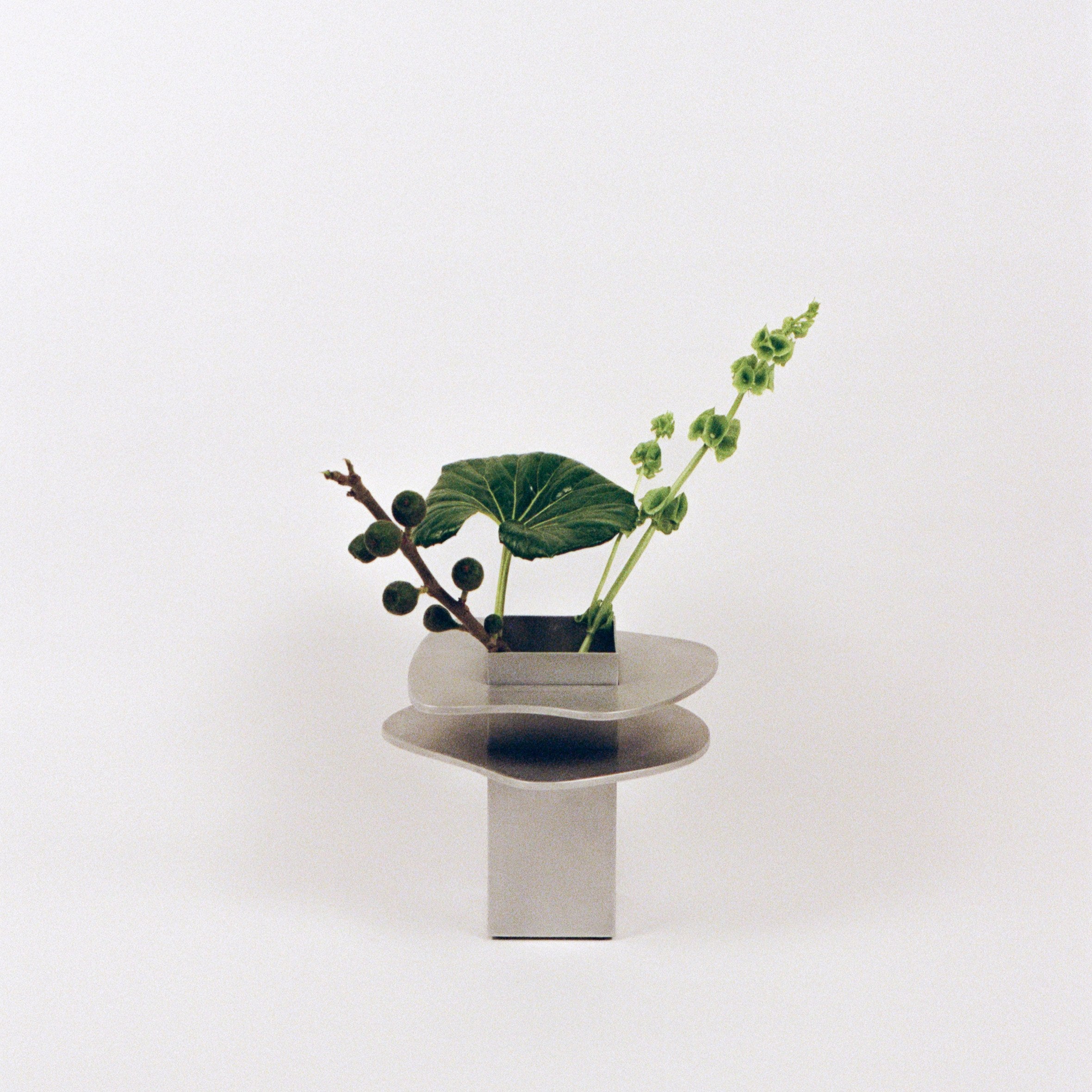 Flange Vase — modern stainless steel vase with greenery