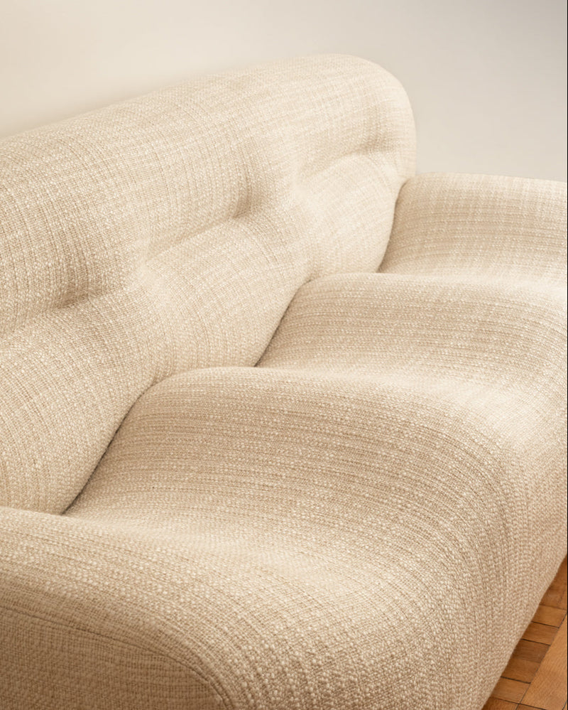 Close-up detail of cream wavy sofa's curved upholstery Italy 1970
