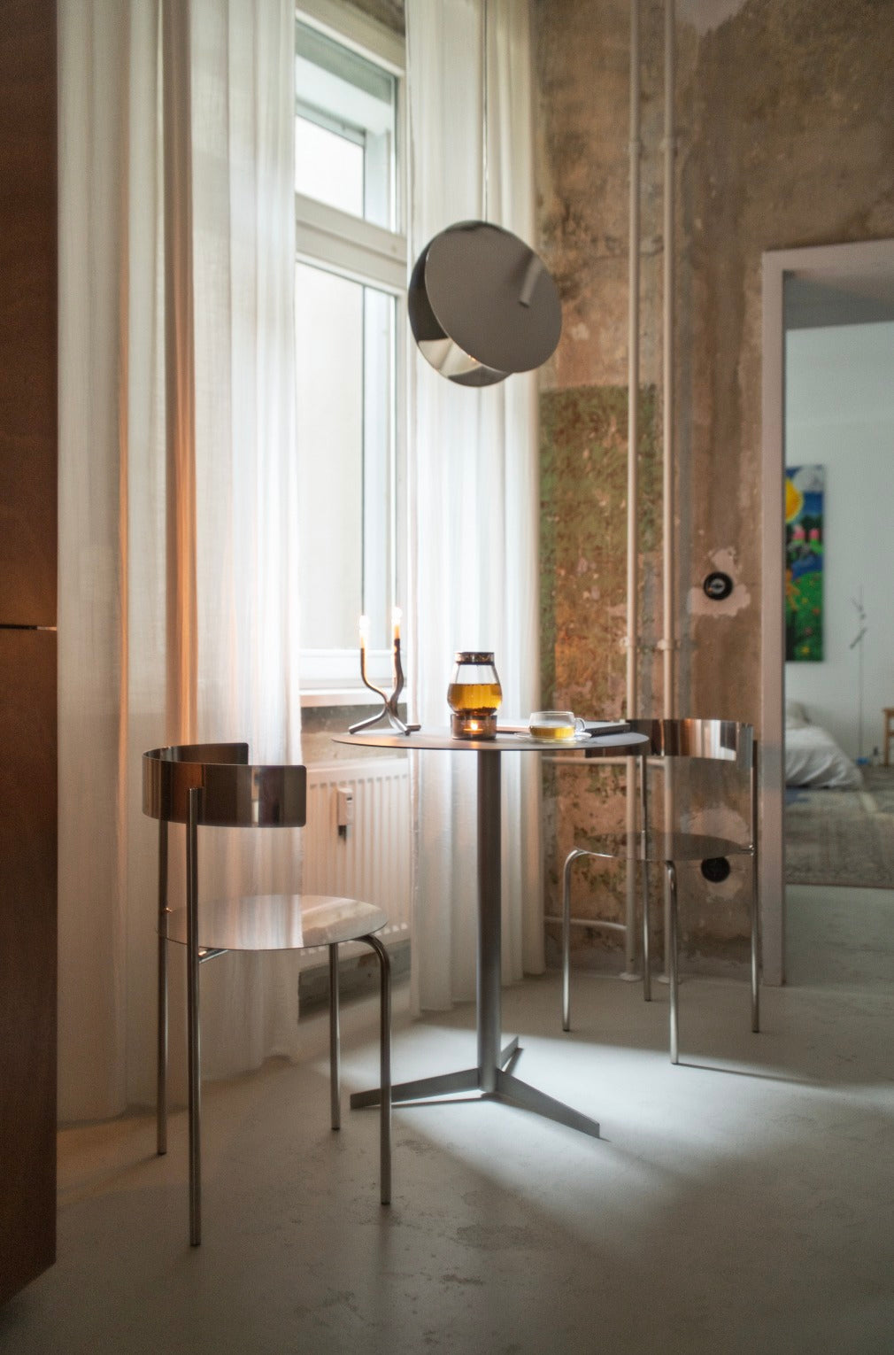 Table - Isla x Paul Delrez - Stainless Steel — top view in modern interior setting