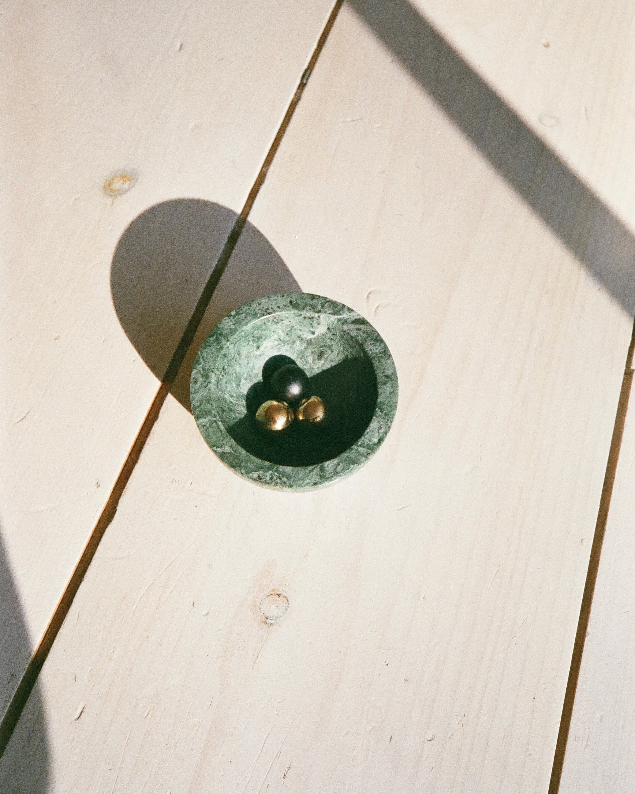 CERCLE Cabinet Knob Small — top view on light wood surface
