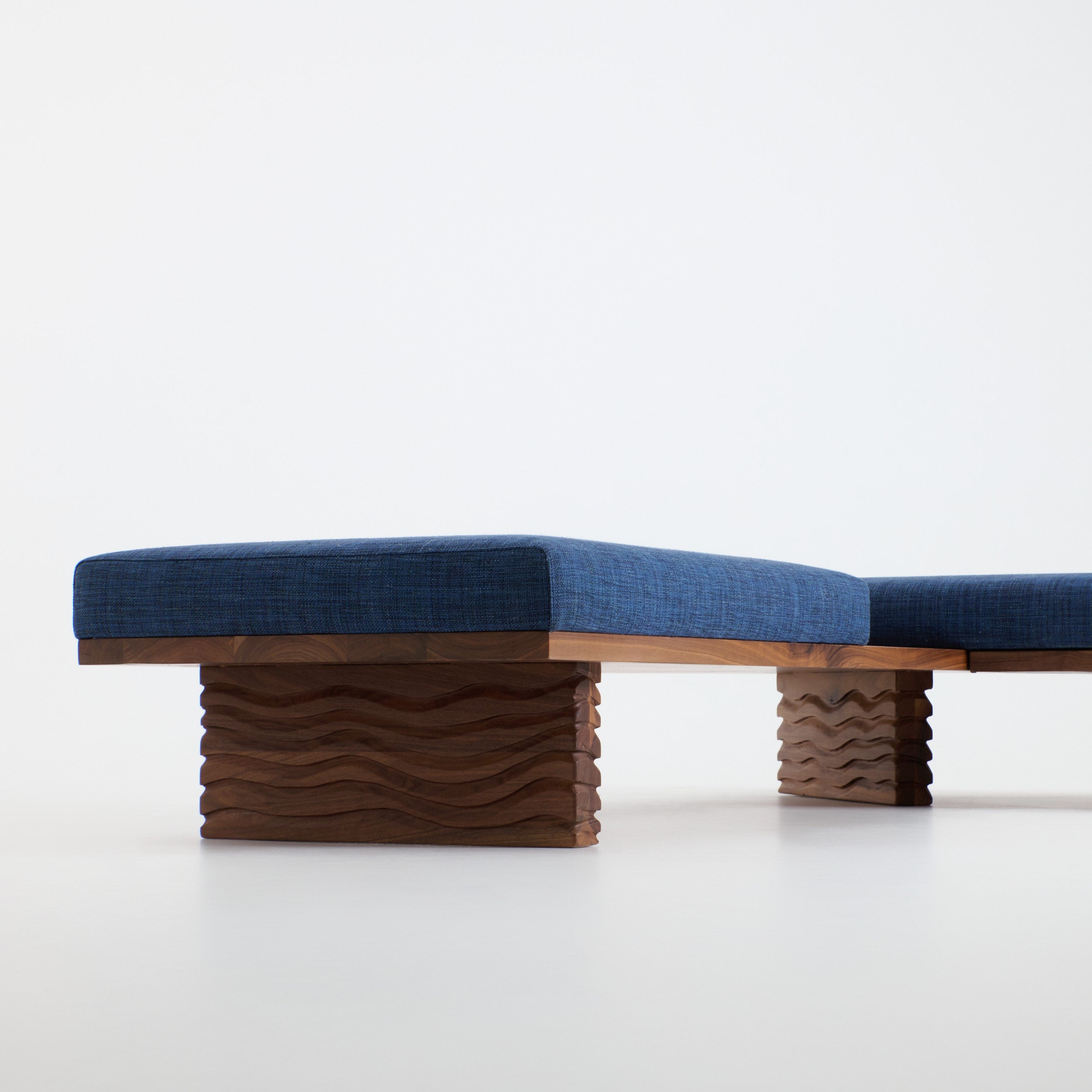 Nazaré Daybed L Shape — close-up of blue fabric on wavy wood base