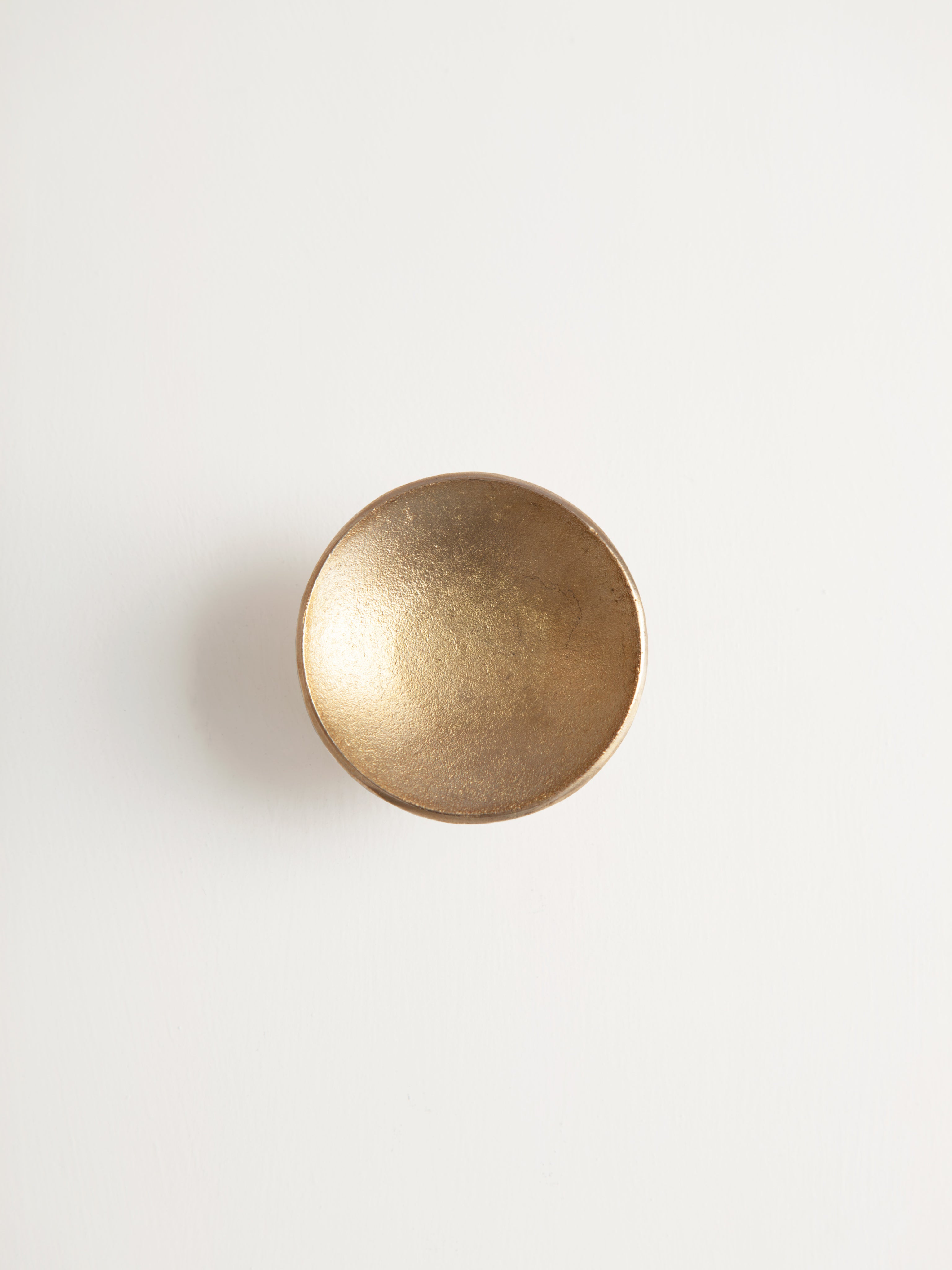 Luna Paper Weight — top view of gold-toned metal surface