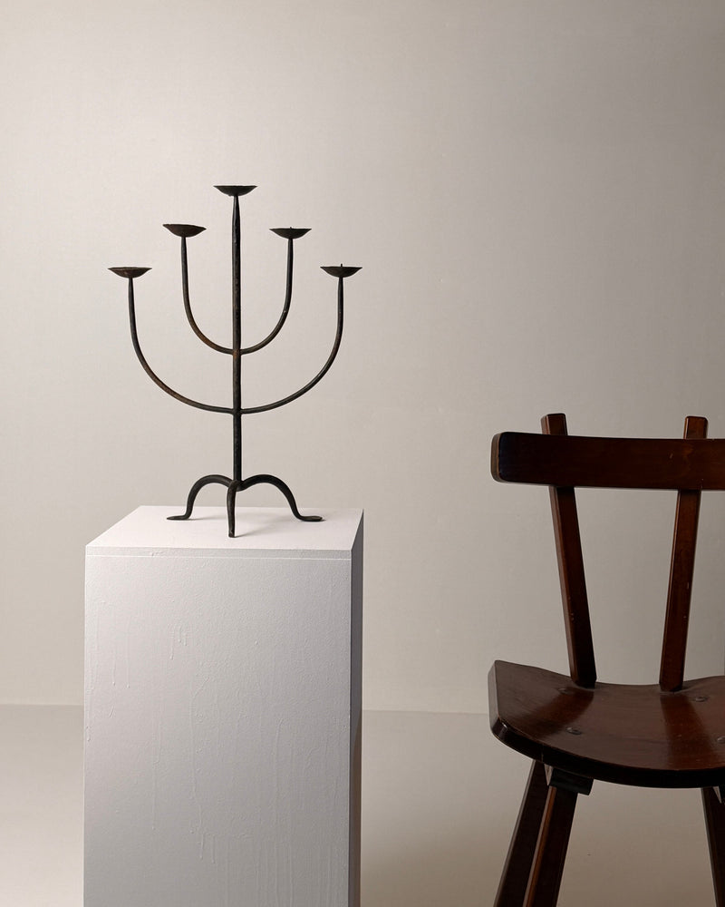 Wrought Iron Candelabrum, France, early 20th century — angled view on white pedestal