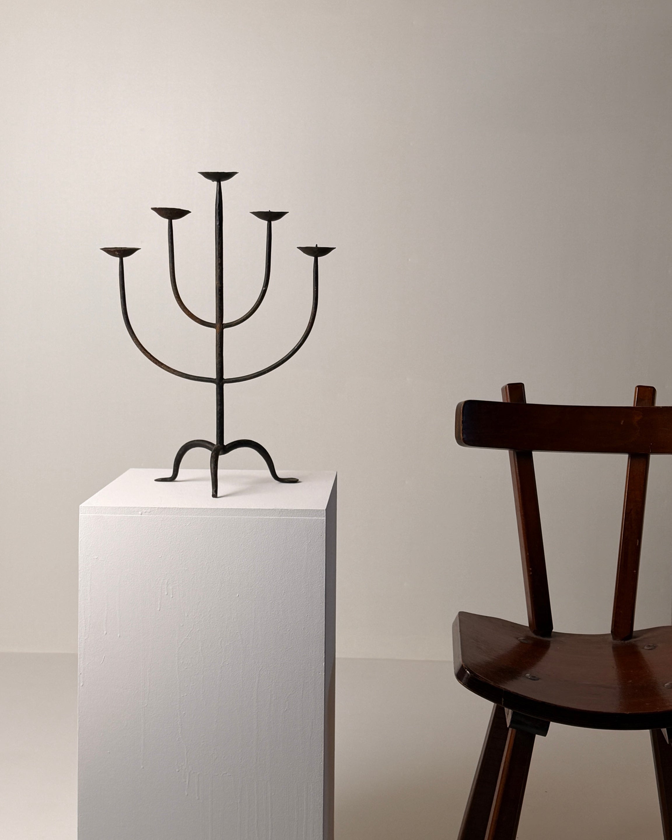 Wrought Iron Candelabrum, France, early 20th century — angled view on white pedestal