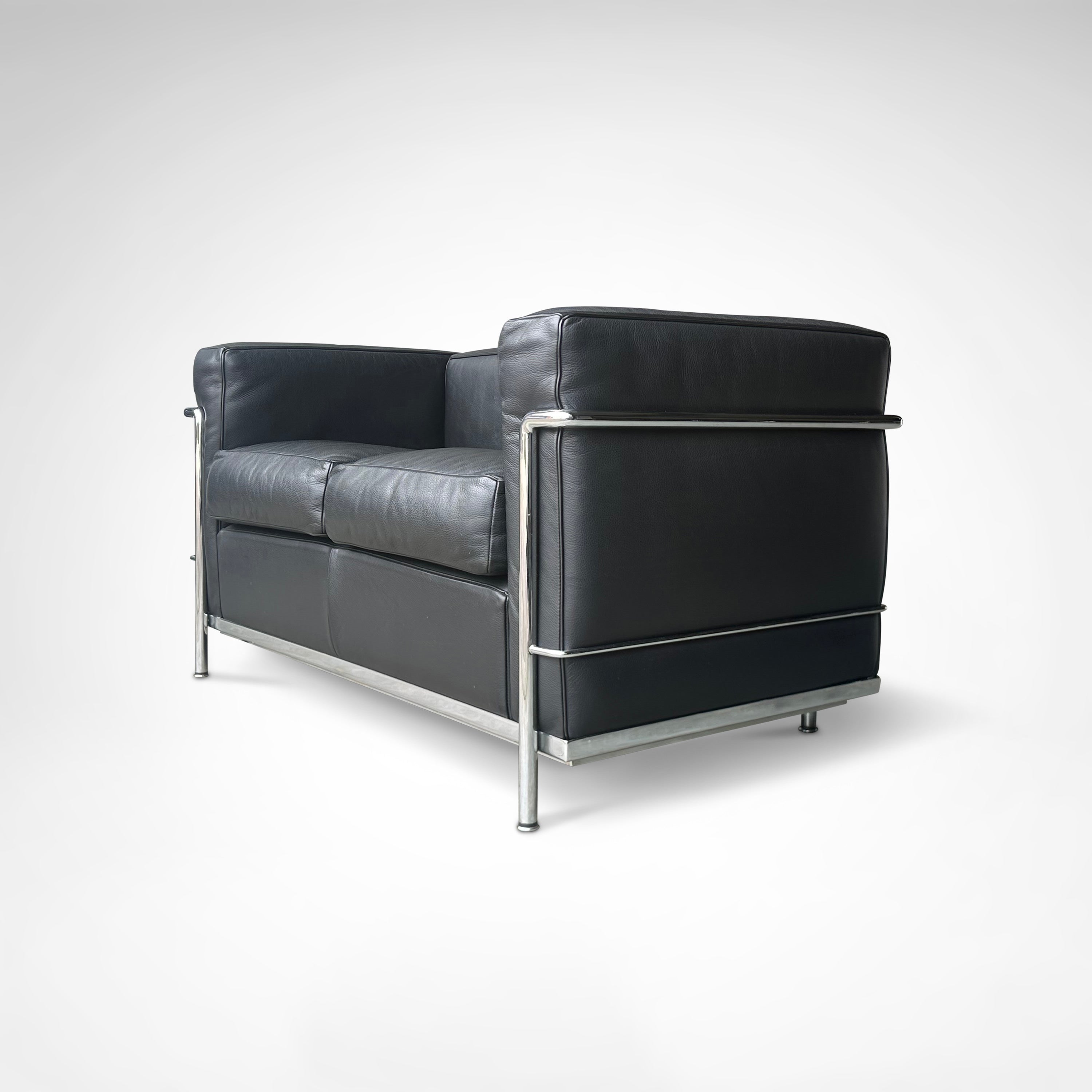 LC2 2-seater sofa by Le Corbusier et al. for Cassina 1990s — side angle showing black leather upholstery and metal frame
