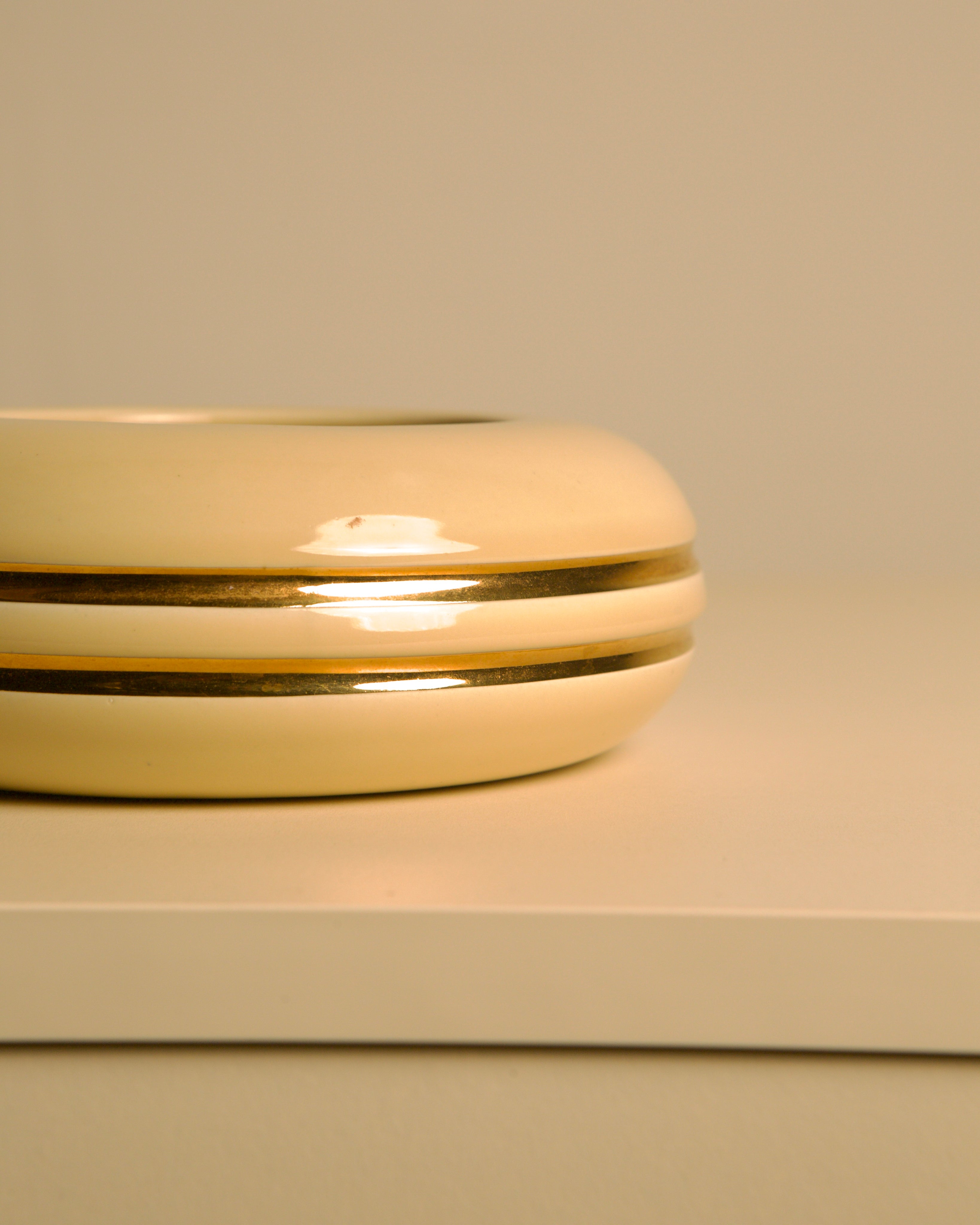 Italian ceramic cream and gold 60's pocket emptier — angled view on light surface