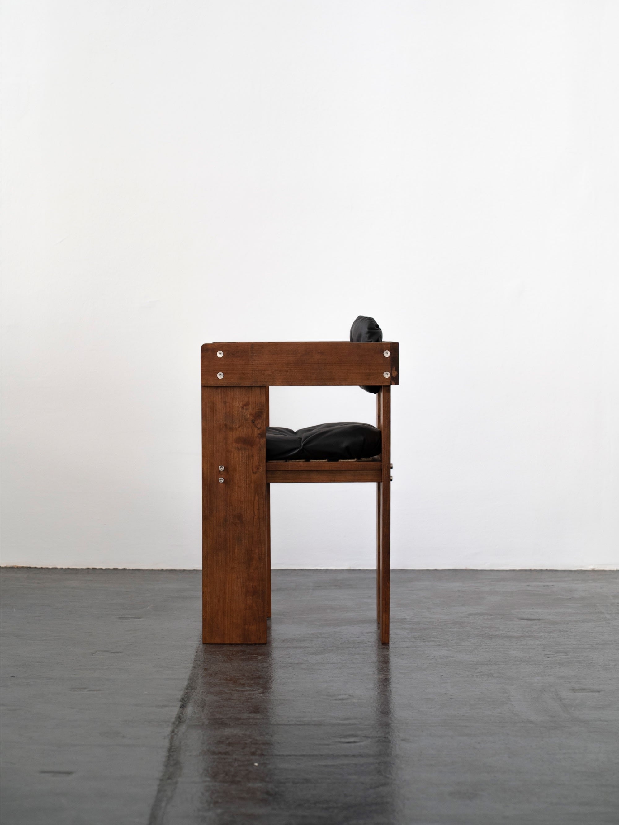Overlap Arm Chair | DN_S2508 — back view highlighting wooden frame and black cushion